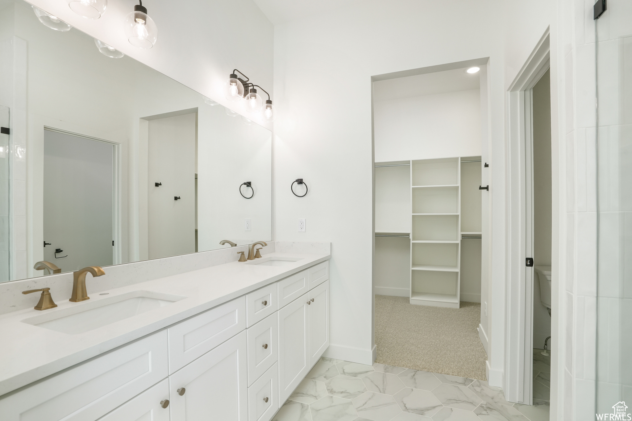 Master Bathroom with large vanity, toilet, double sink, and tile flooring