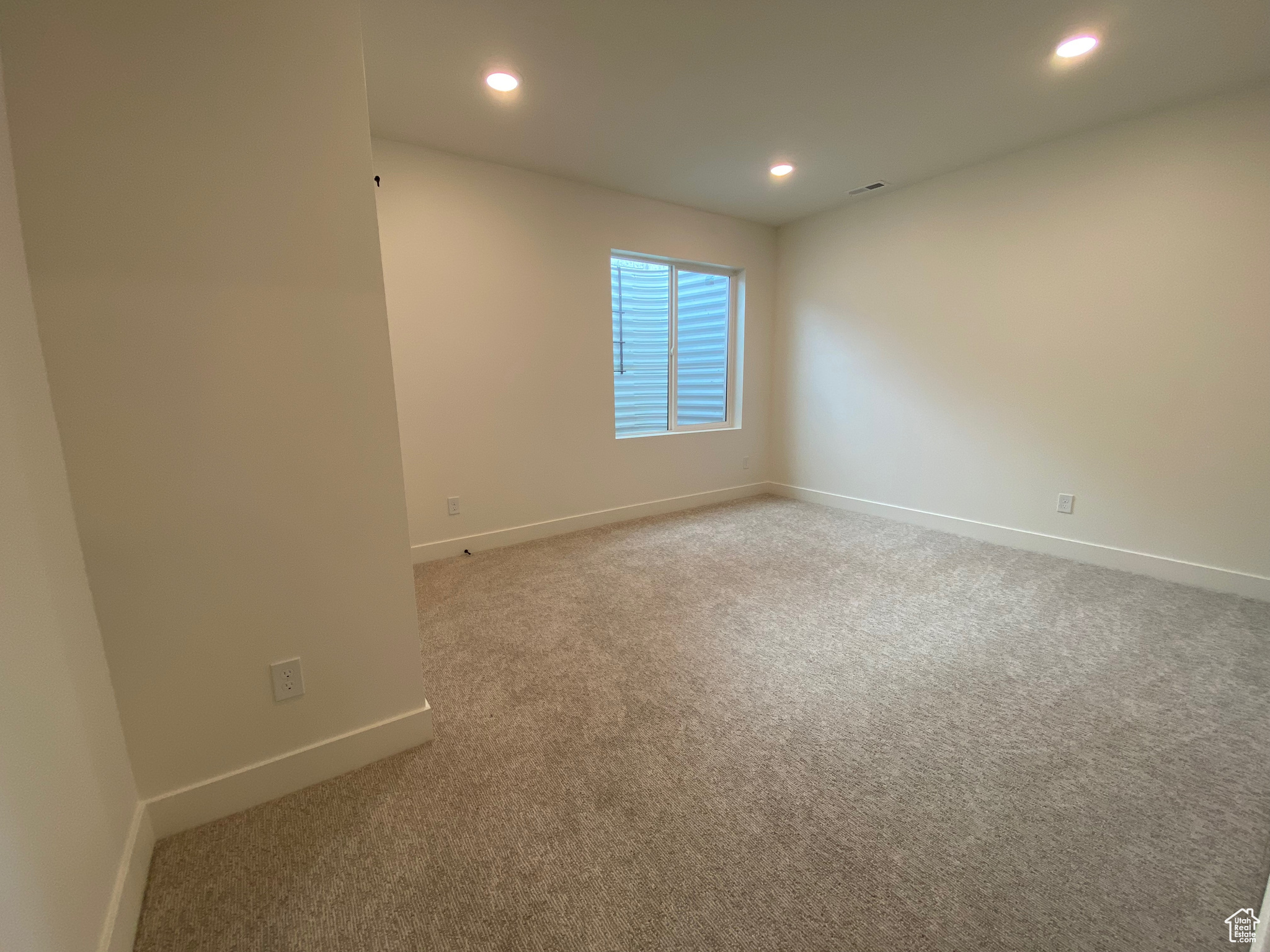 Unfurnished bedroom featuring a closet and light carpet