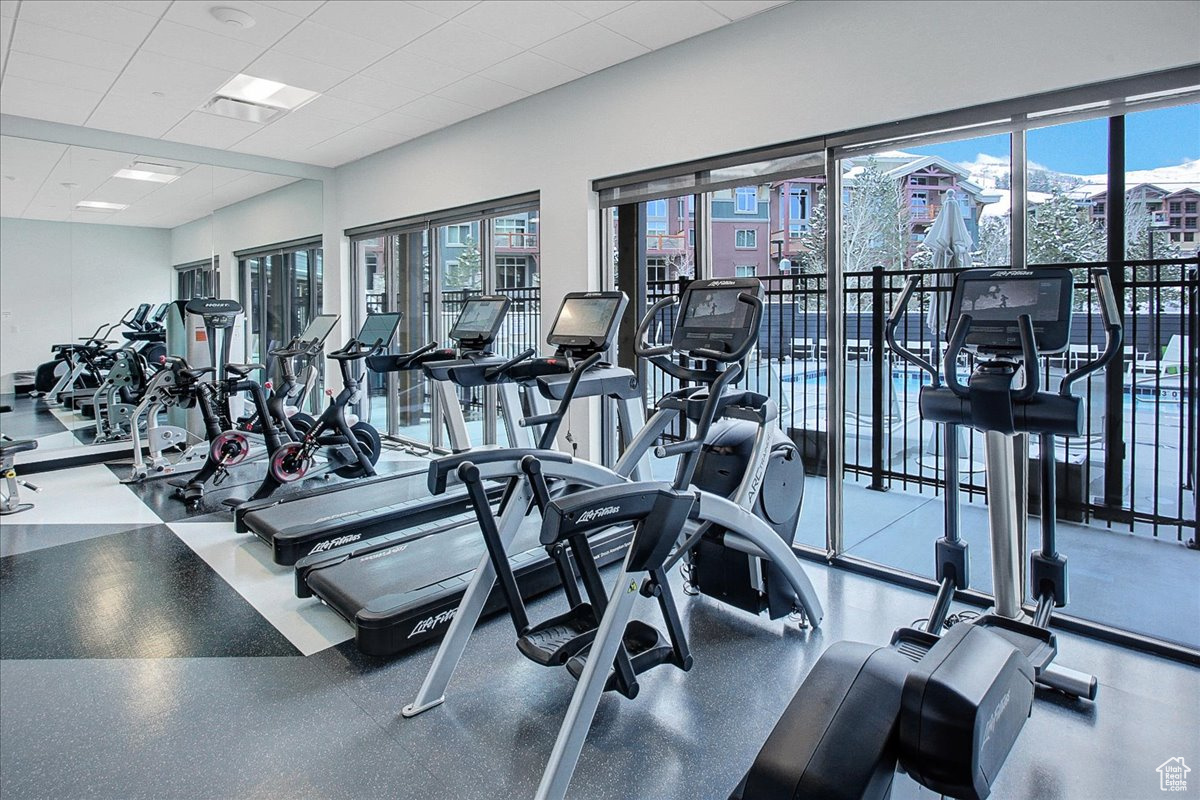 Workout area with plenty of natural light and a drop ceiling