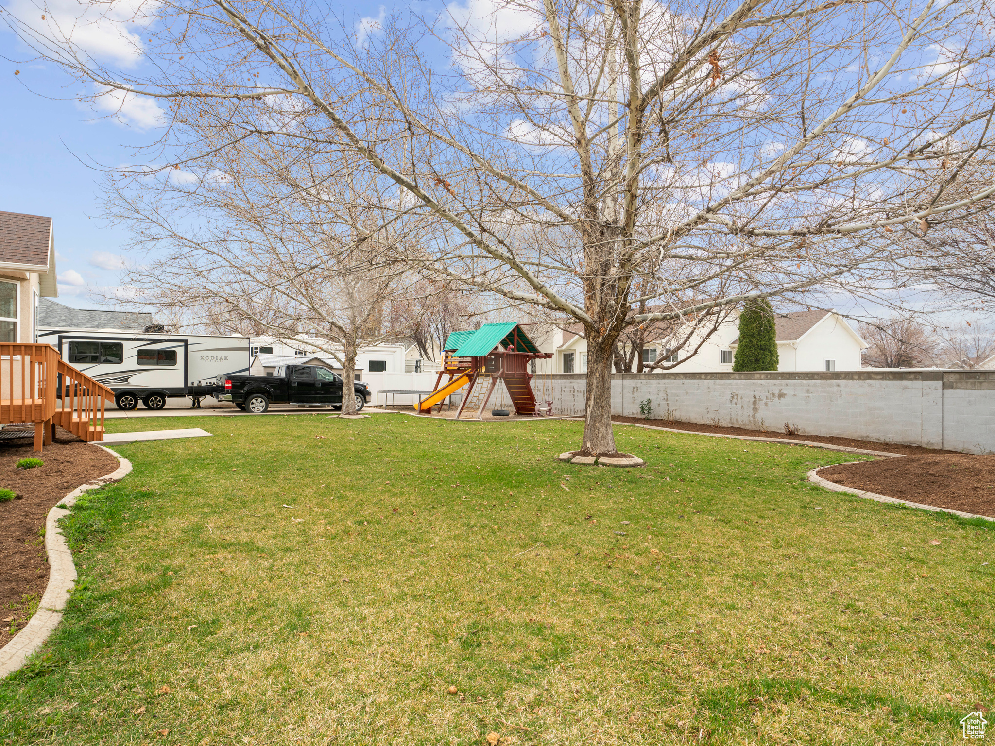 Backyard w/ view of oversized RV Pad and shed