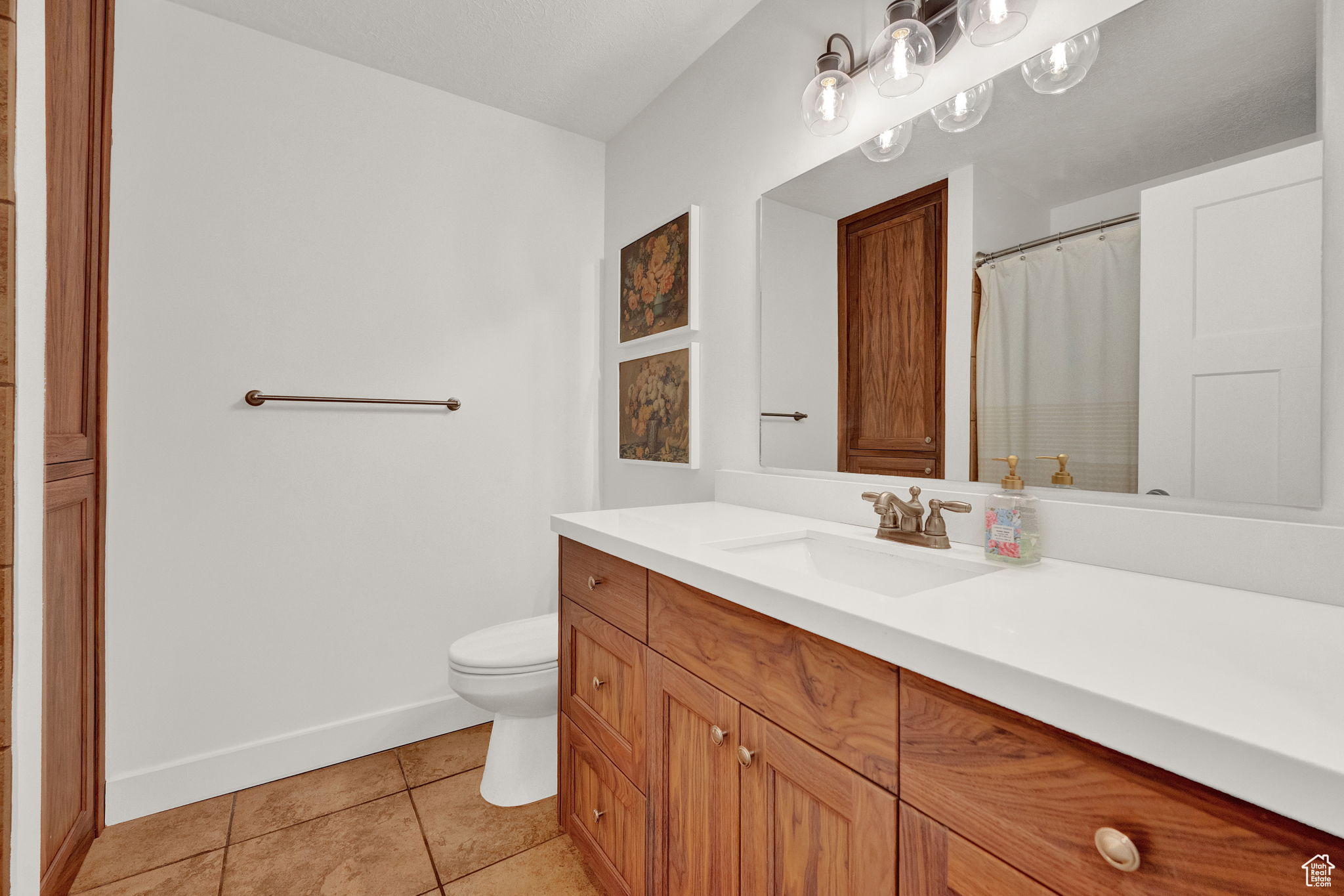 Bathroom with oversized vanity, tile floors, and toilet
