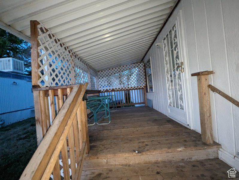 View of wooden deck leading to door entry
