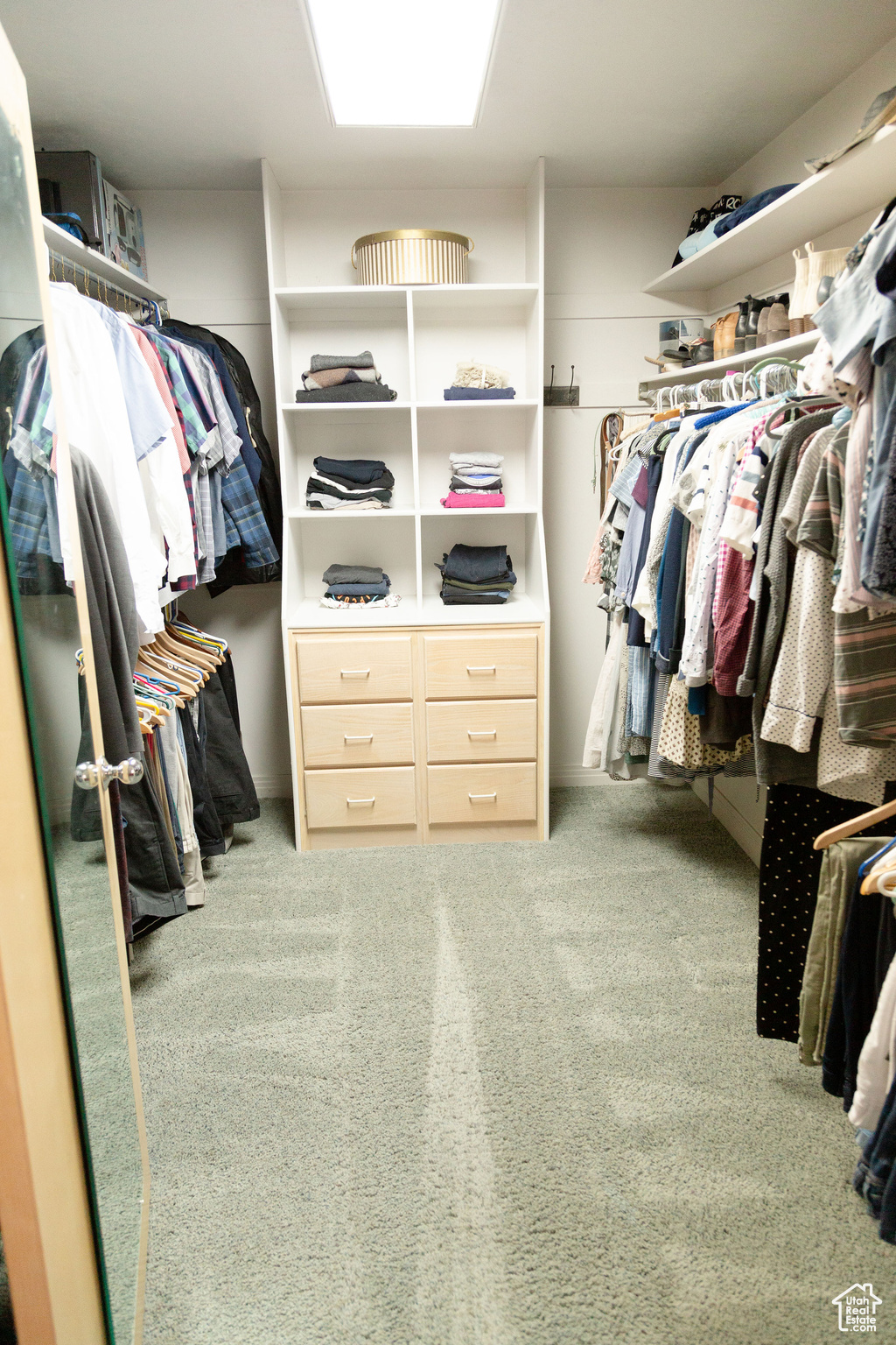 Master spacious walk in closet with carpet flooring