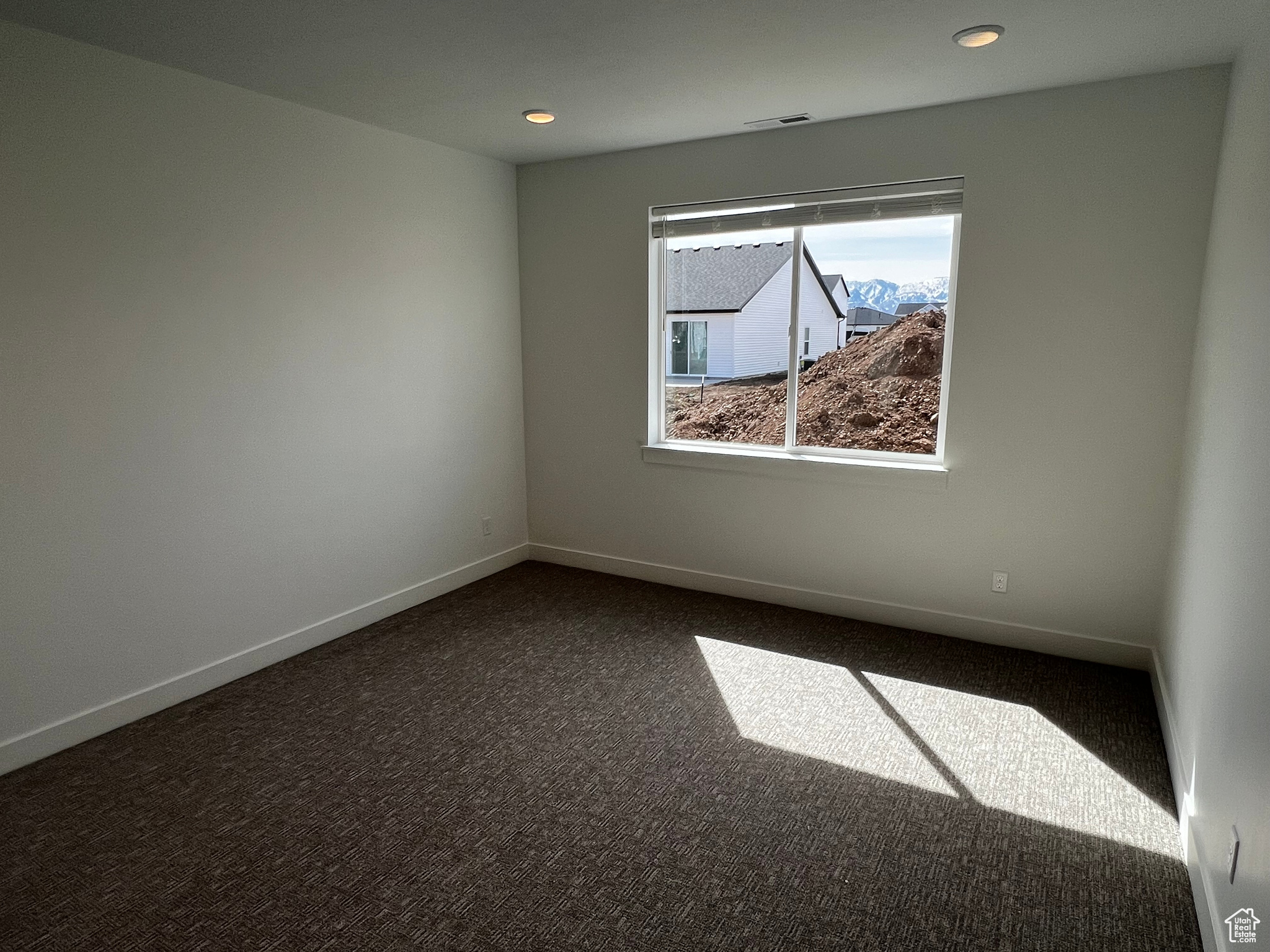 View of carpeted spare room