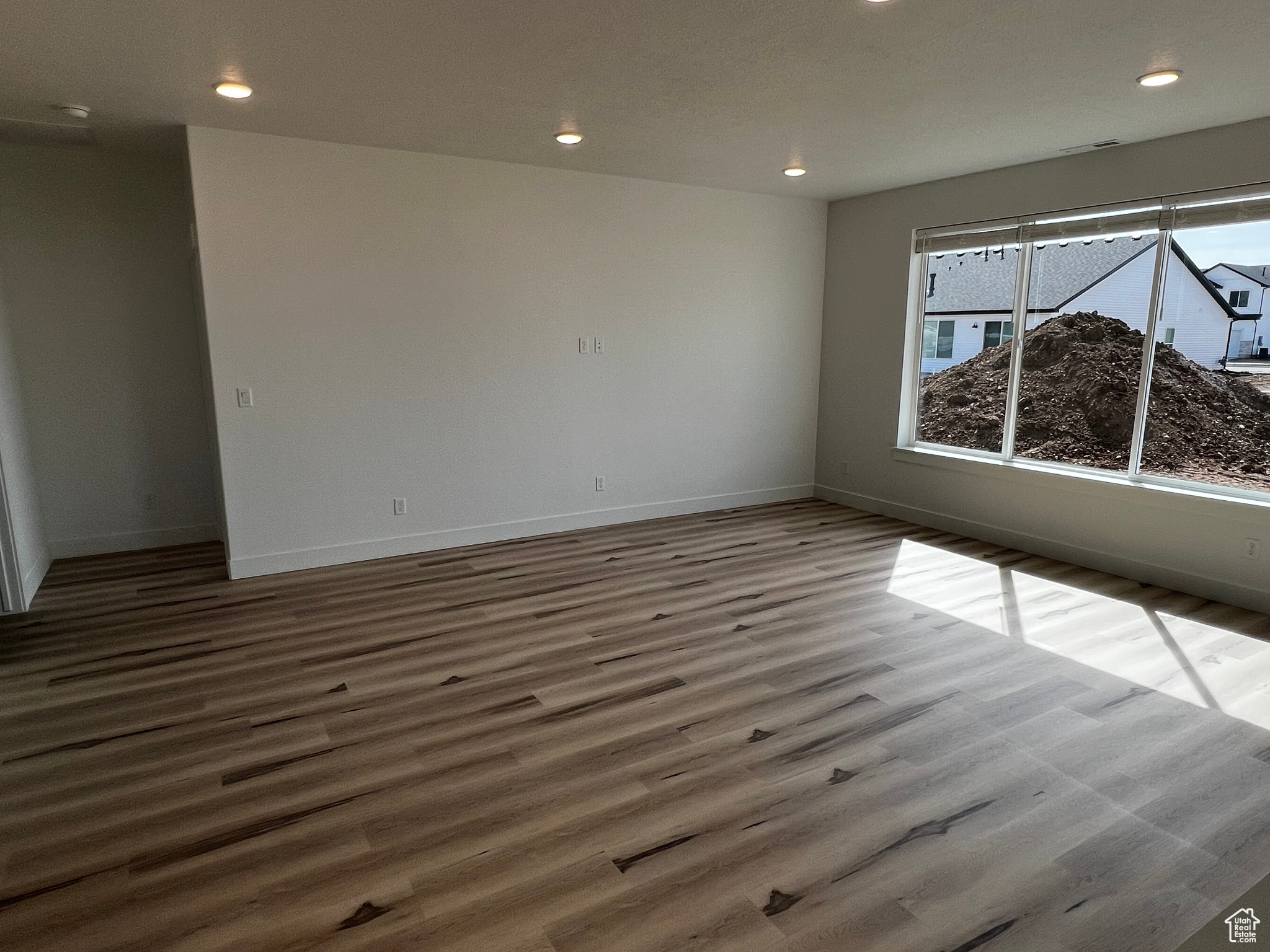 Empty room with light hardwood / wood-style floors