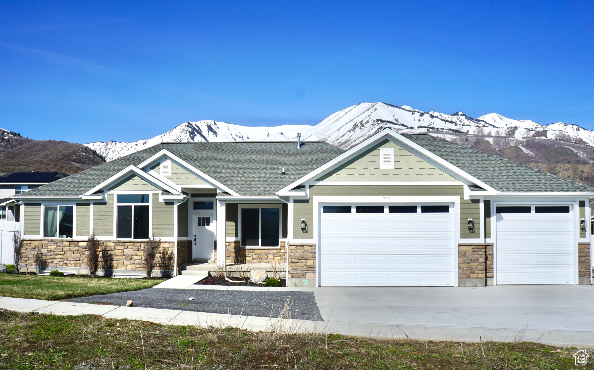 Craftsman-style house with a mountain view and a three-car garage