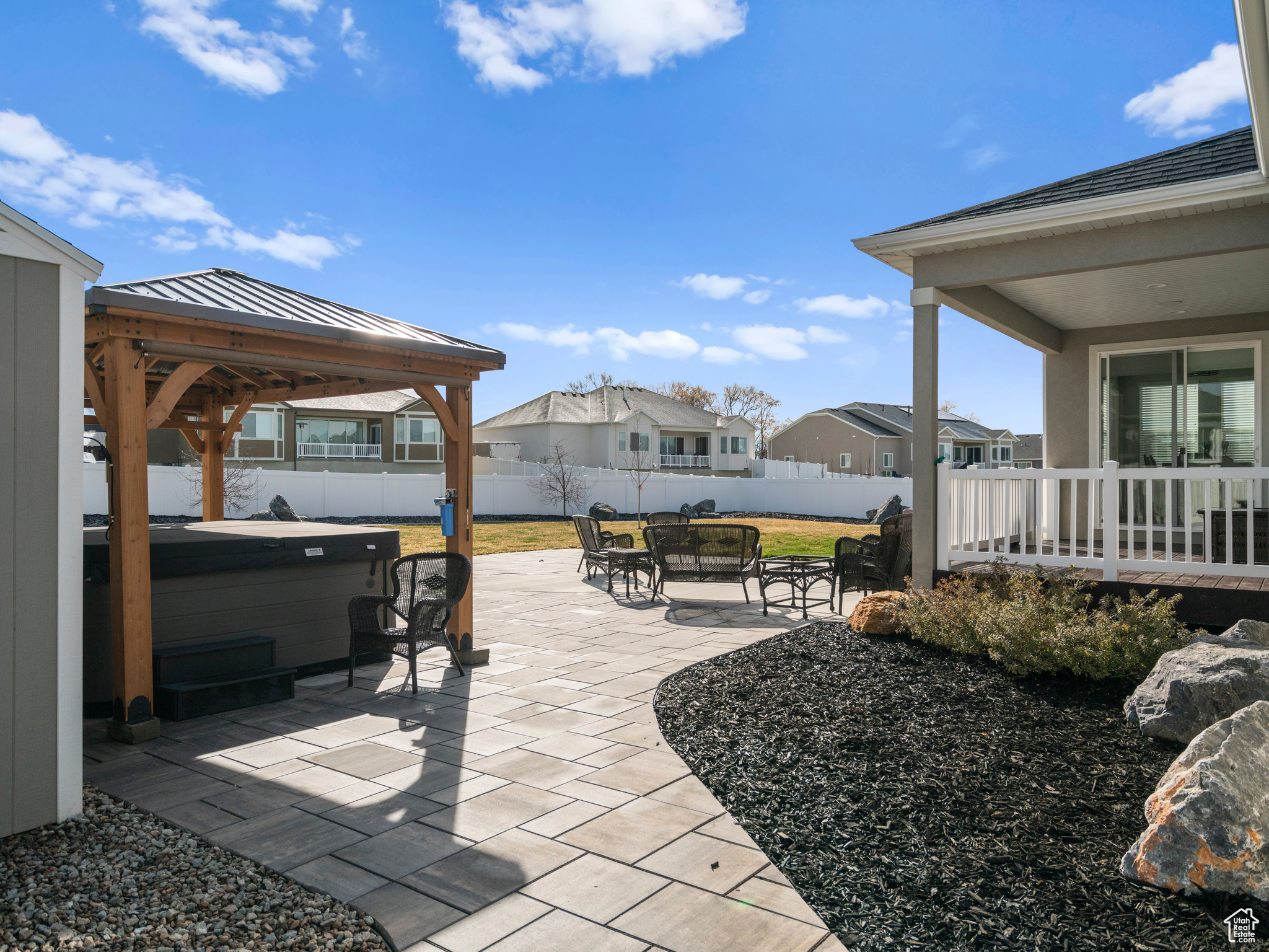 View of terrace featuring a gazebo and a hot tub