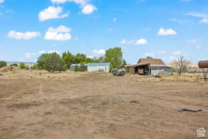 View of yard with an outbuilding and a rural view