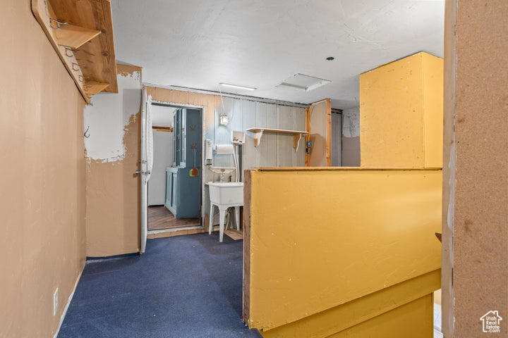 Kitchen with dark colored carpet and sink