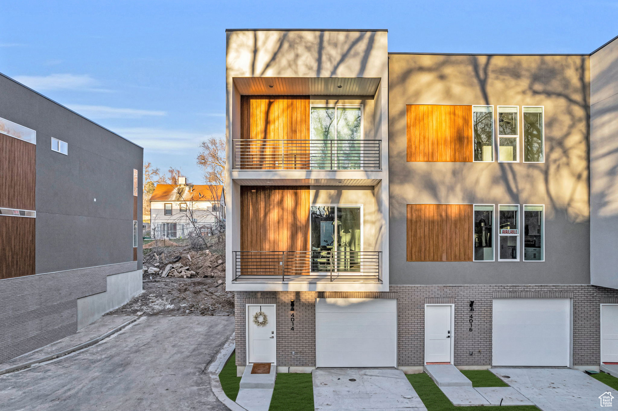 View of front of property with a balcony and a garage