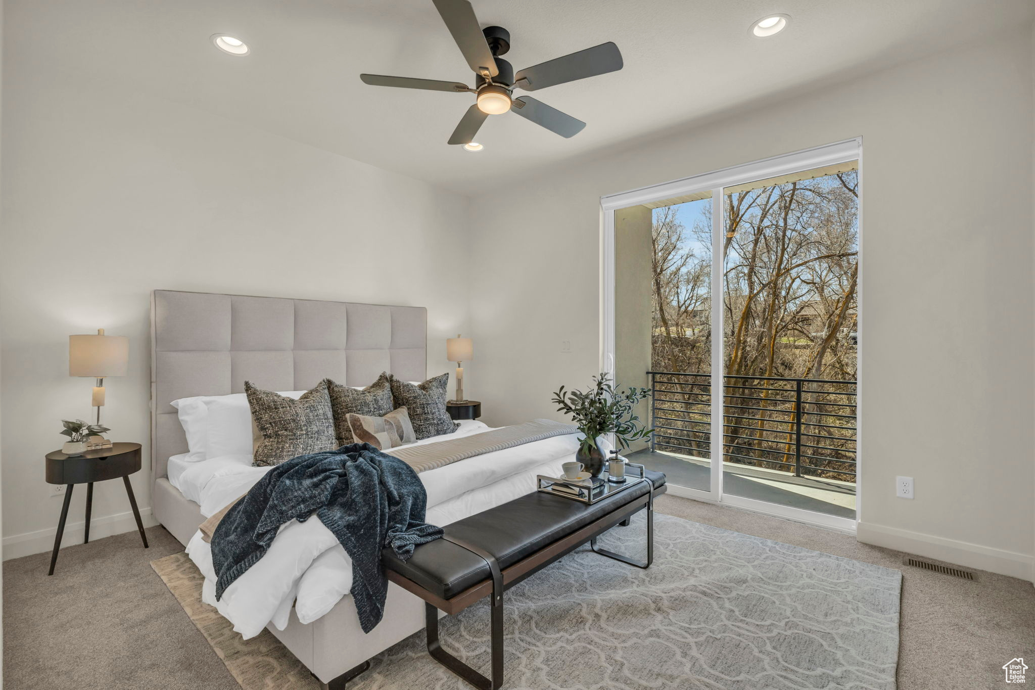 Bedroom with light carpet, ceiling fan, and access to outside