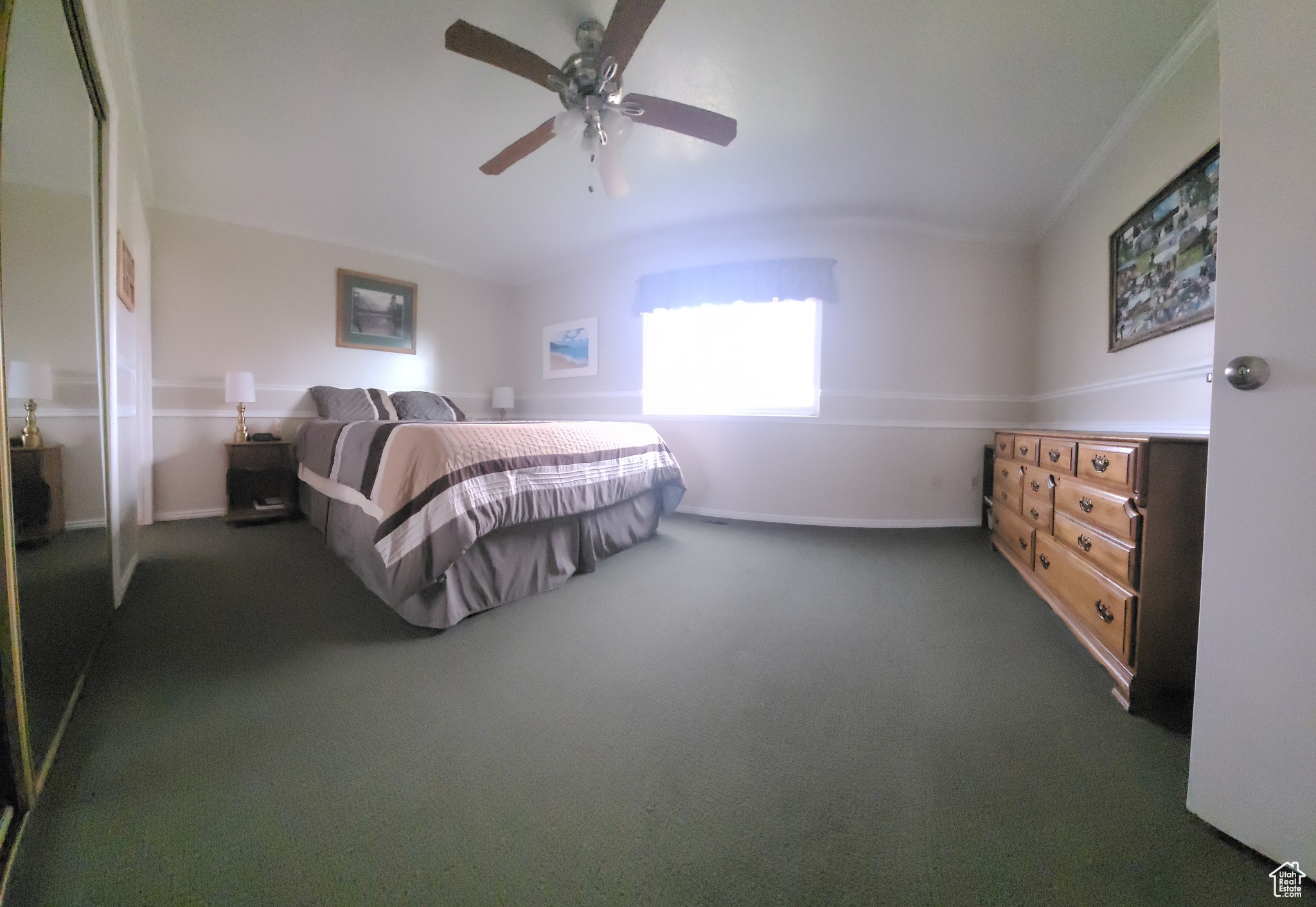 Primary Bedroom, Carpeted bedroom with ornamental molding and ceiling fan