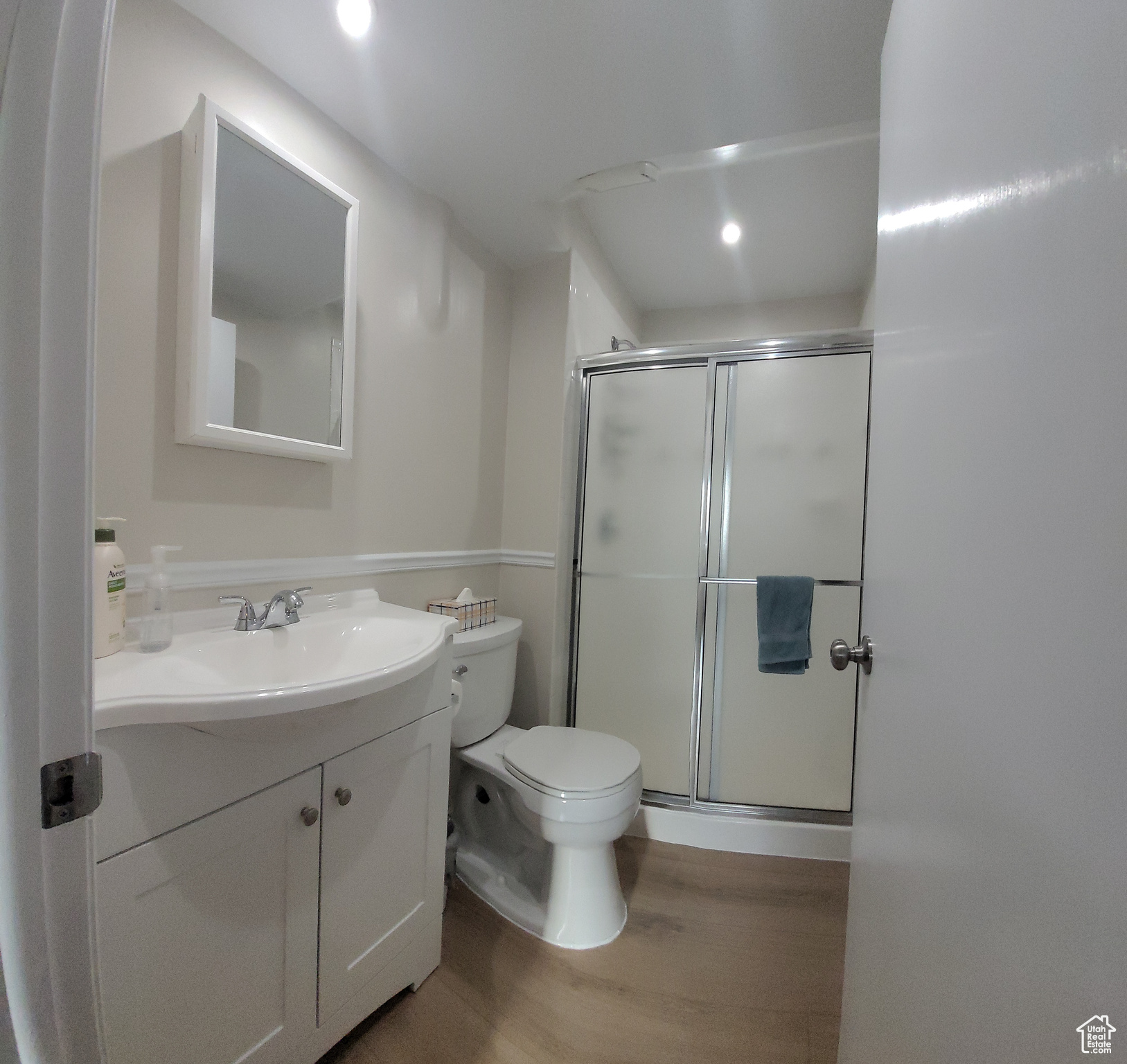 3rd Bathroom with toilet, wood-type flooring, a shower with shower door, and vanity