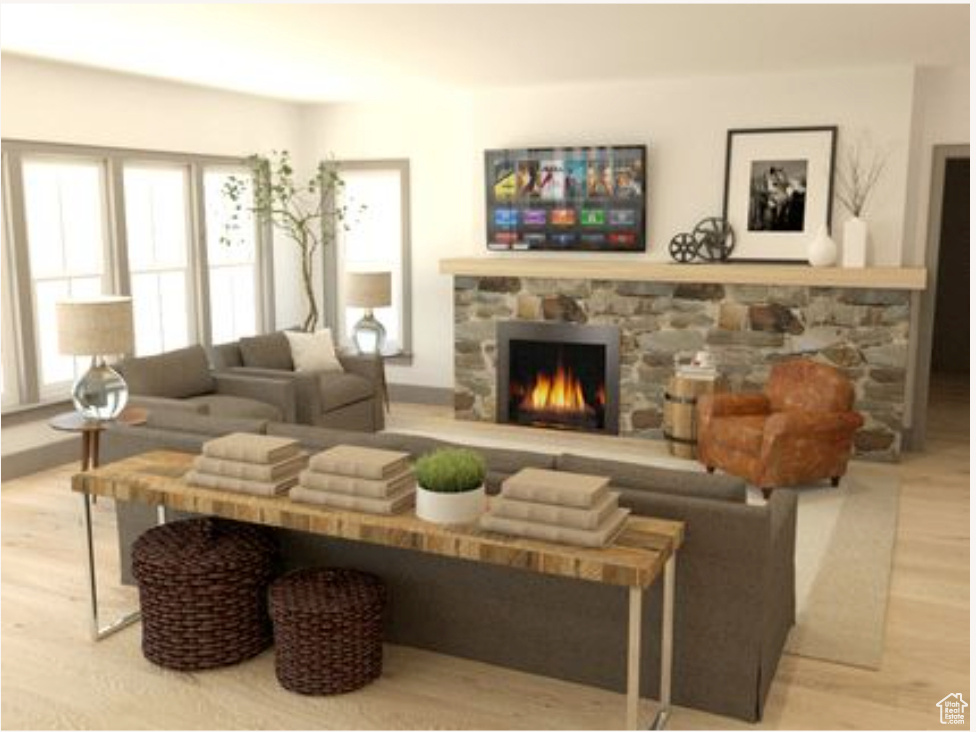 Living room featuring light wood-type flooring and a fireplace