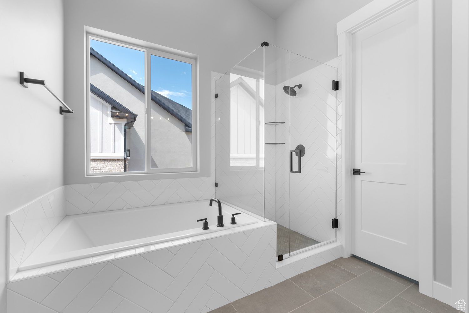 Bathroom with independent shower and bath and tile patterned floors