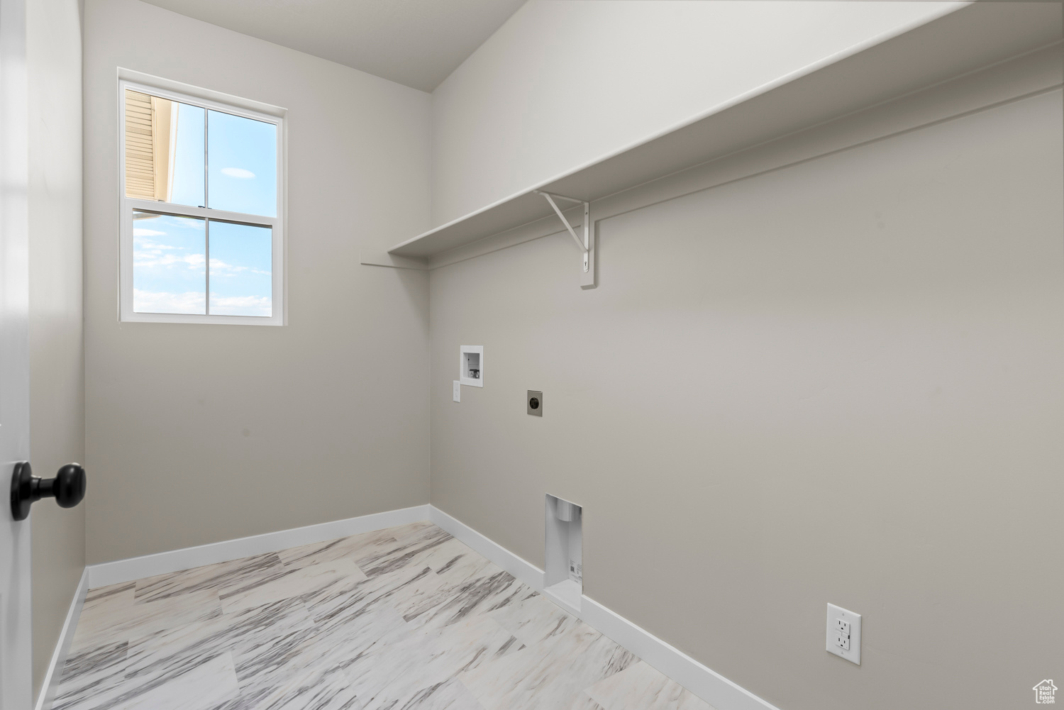 Laundry room with light tile patterned flooring, electric dryer hookup, and hookup for a washing machine