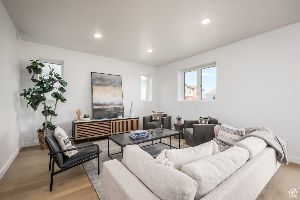 Model Home Photo. Living room featuring light hardwood / wood-style flooring