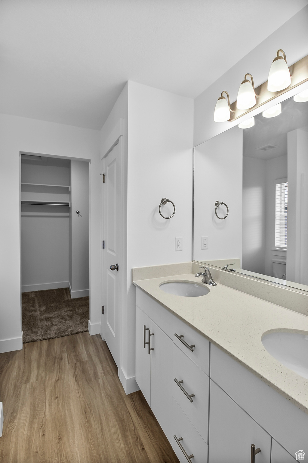 Bathroom featuring oversized vanity, hardwood / wood-style floors, and double sink