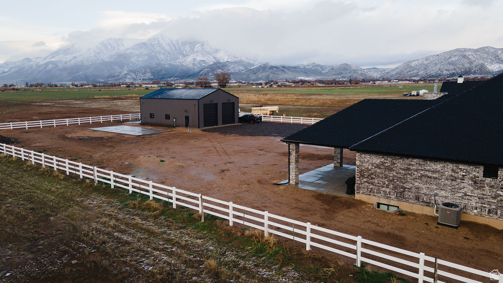 View of stable with a mountain view, a rural view, and a storage shed