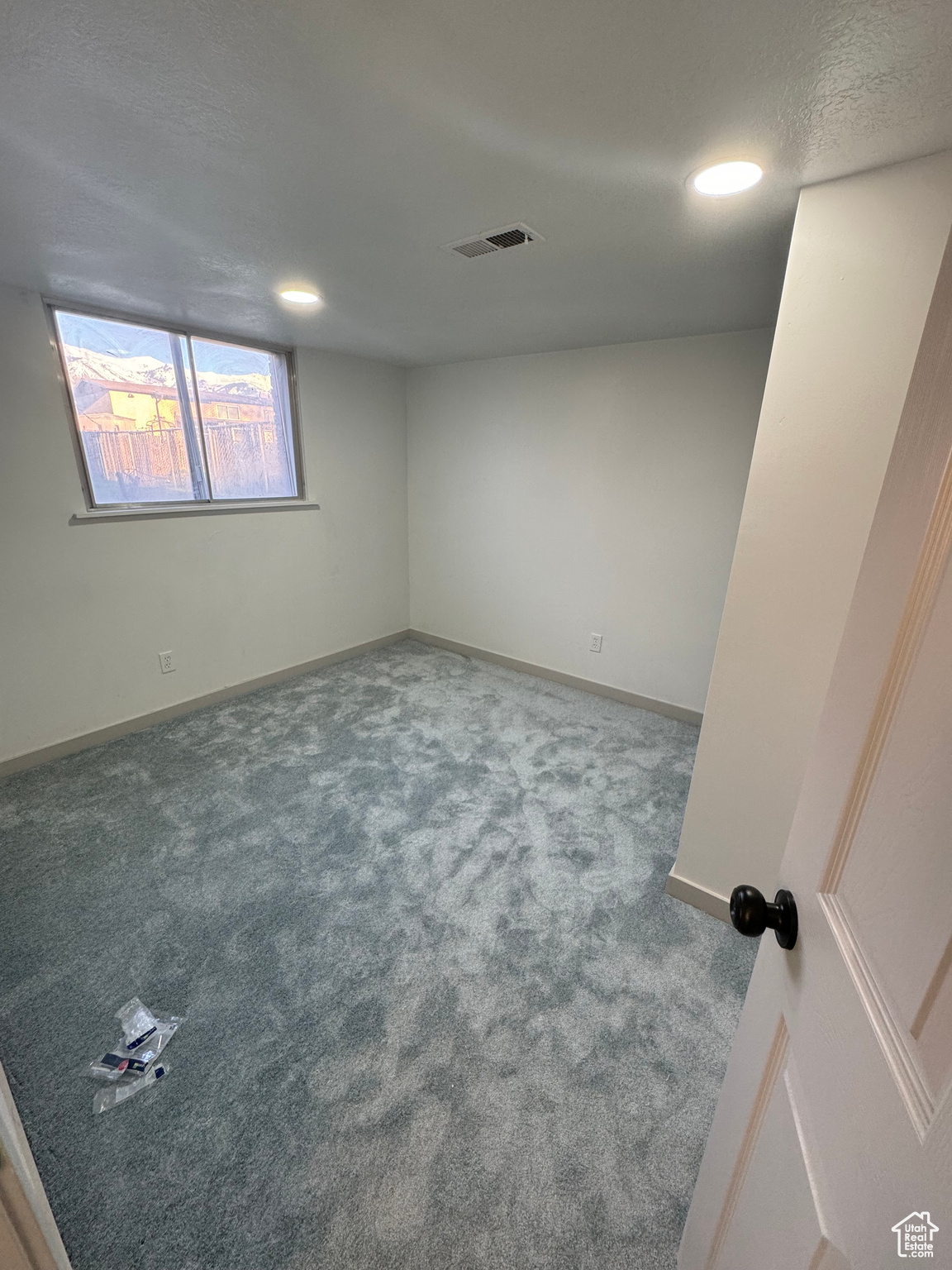 Spare room featuring carpet flooring