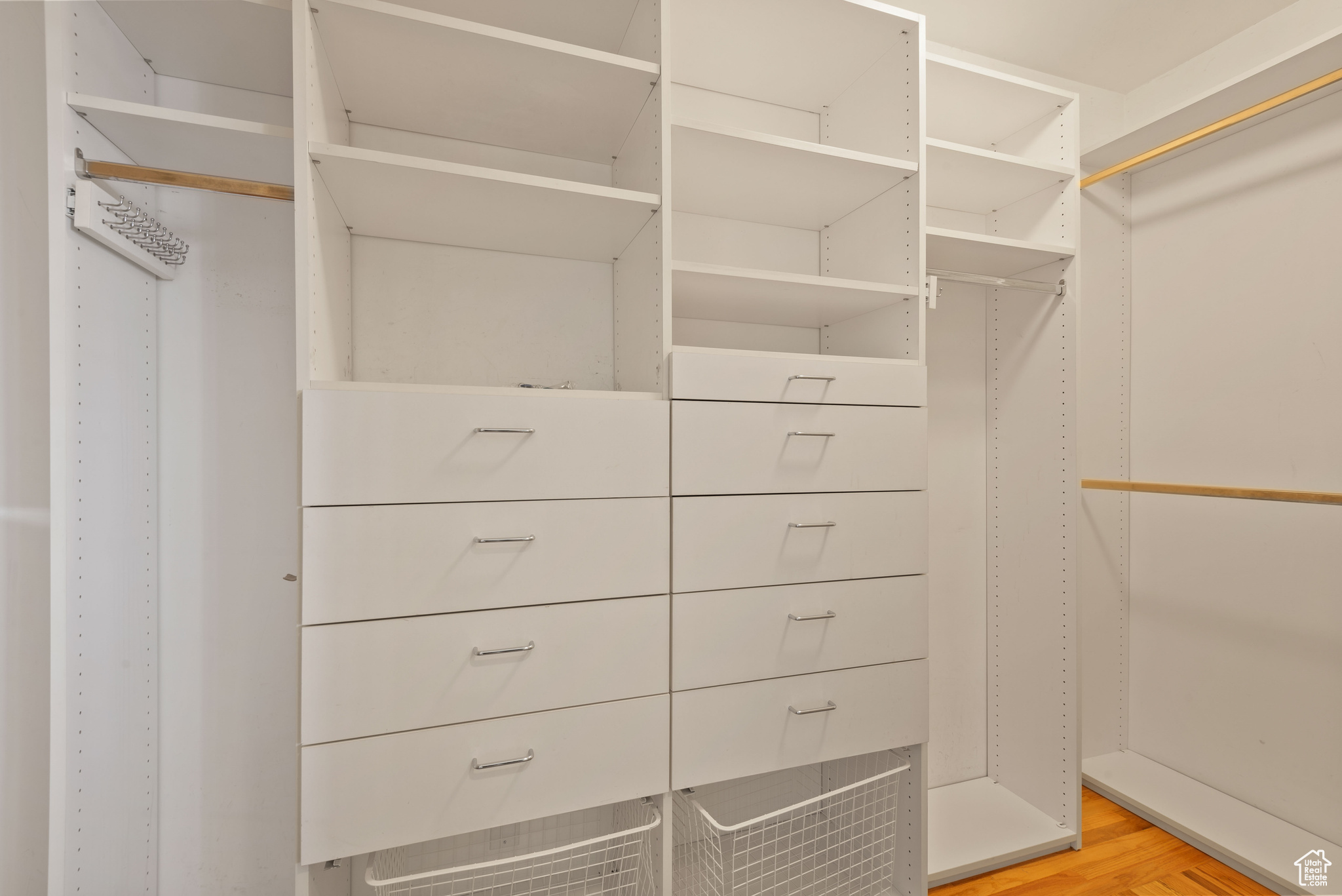 Master bedroom walk-in  closet with built in shelving and drawers.