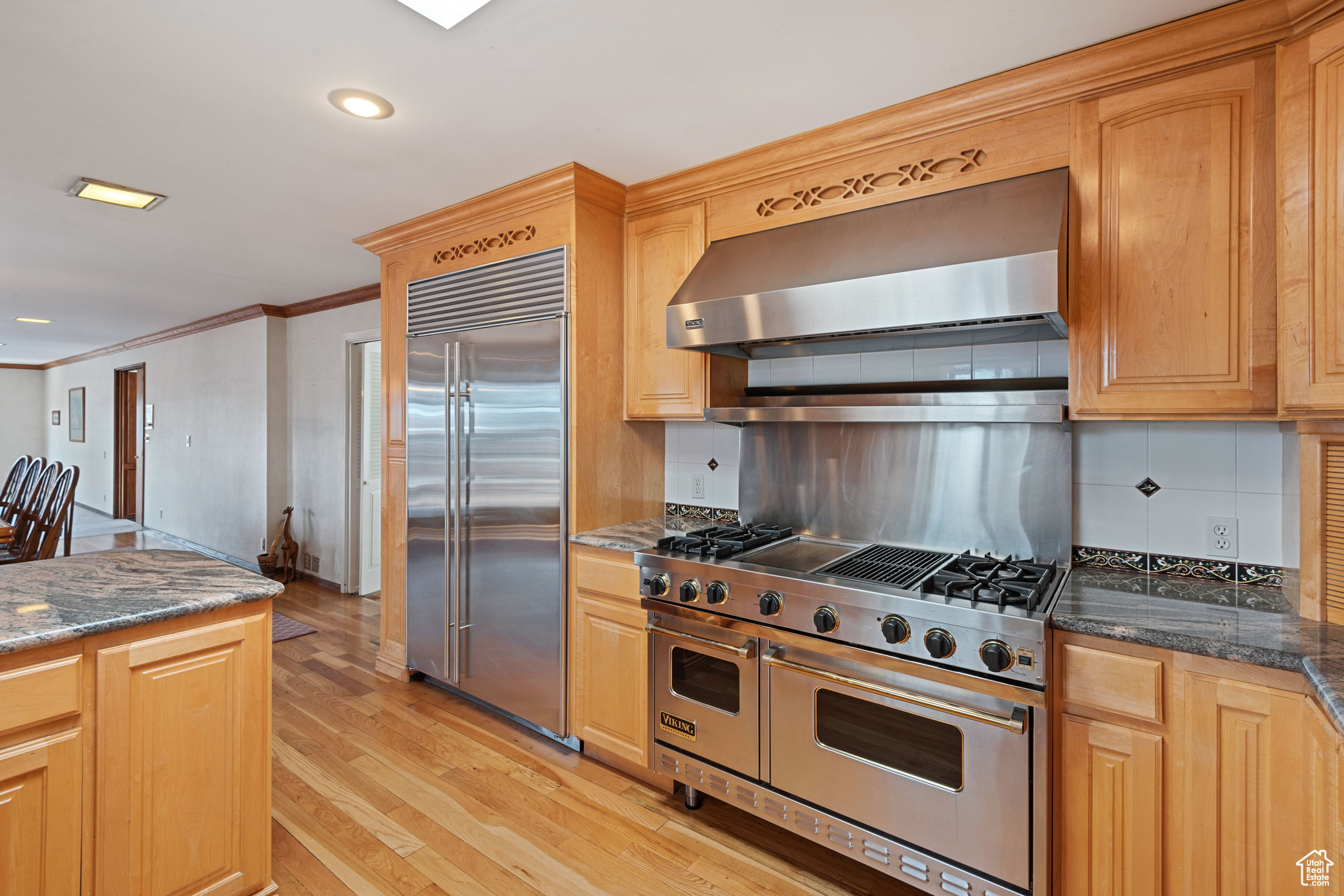 Kitchen with  Viking Gas Range, wall chimney range hood, Sub Zero Refrigerator/Freezer