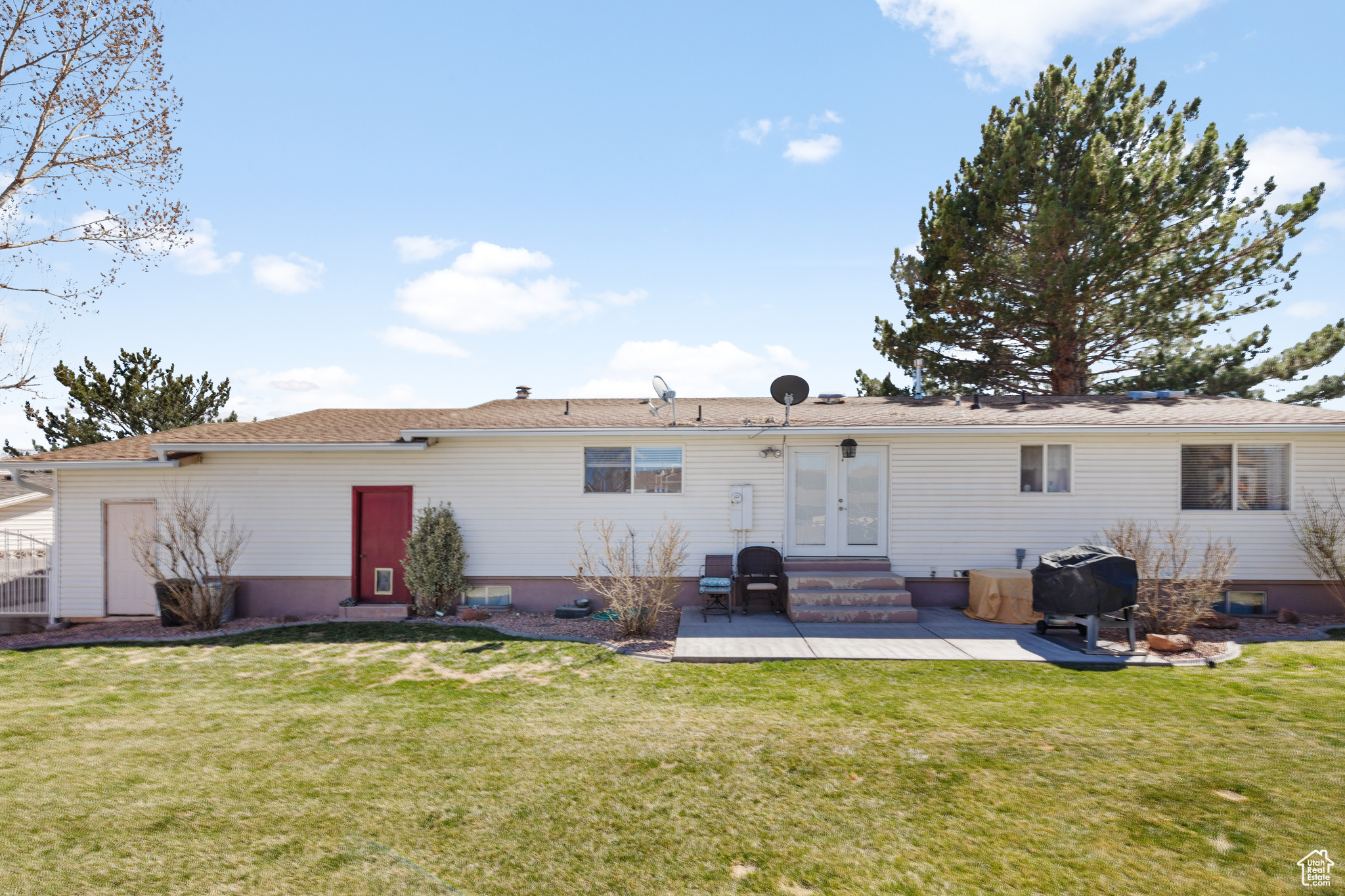 Back of house featuring a yard and a patio area