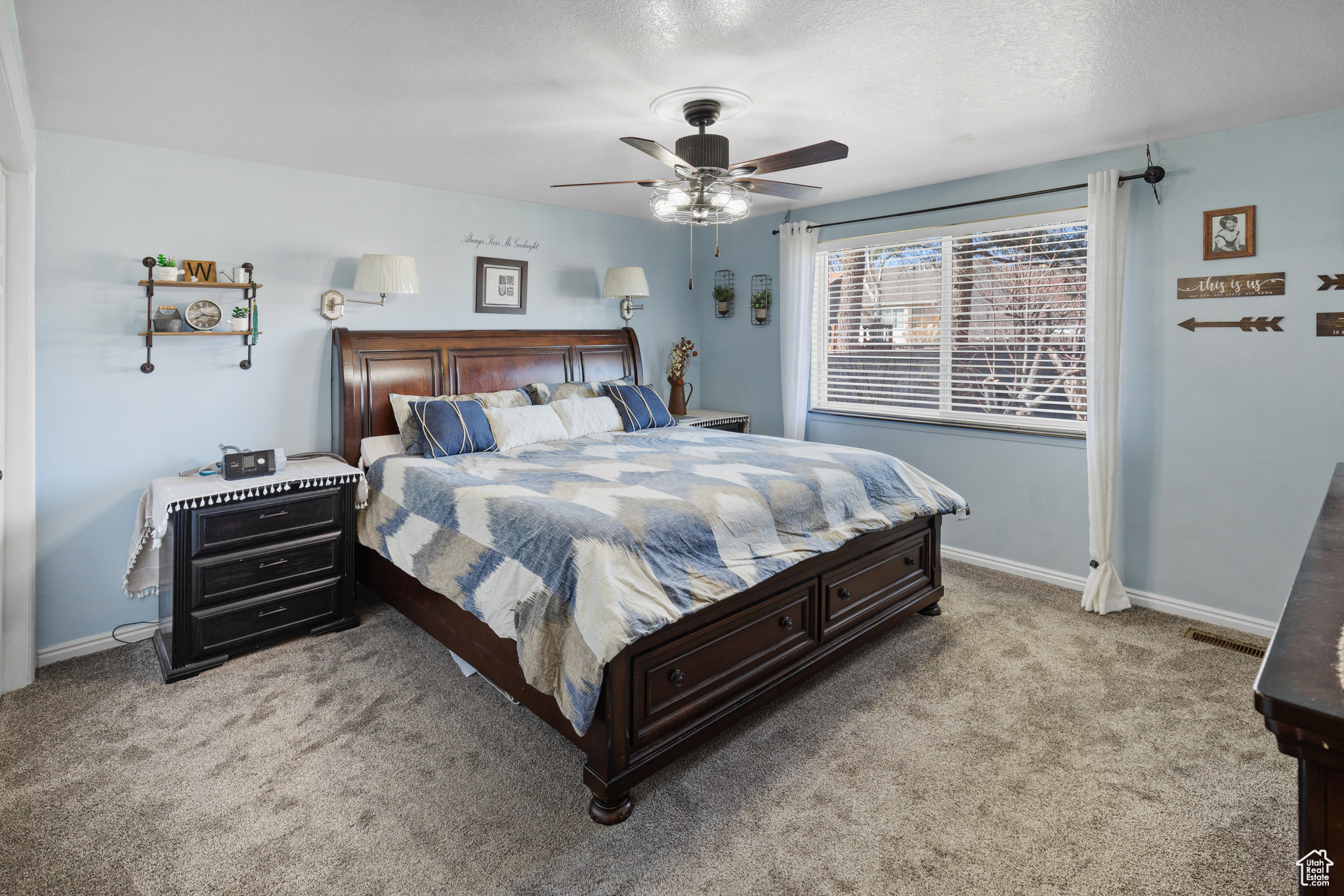 Bedroom featuring ceiling fan and light carpet