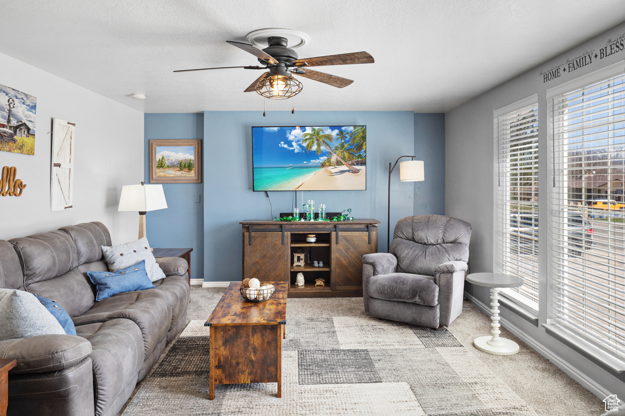 Living room with light carpet and ceiling fan