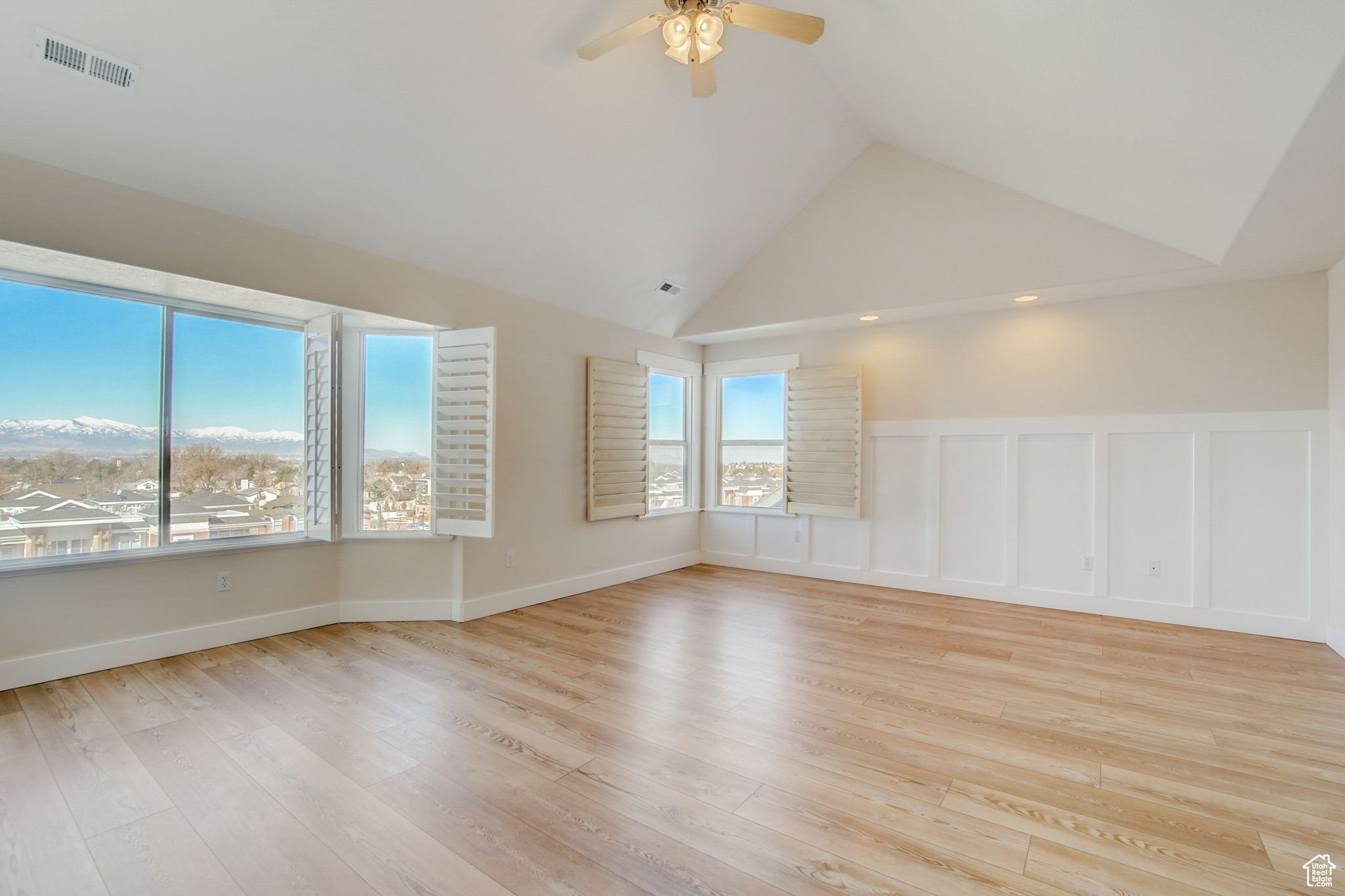 Unfurnished room with high vaulted ceiling, ceiling fan, and light wood-type flooring