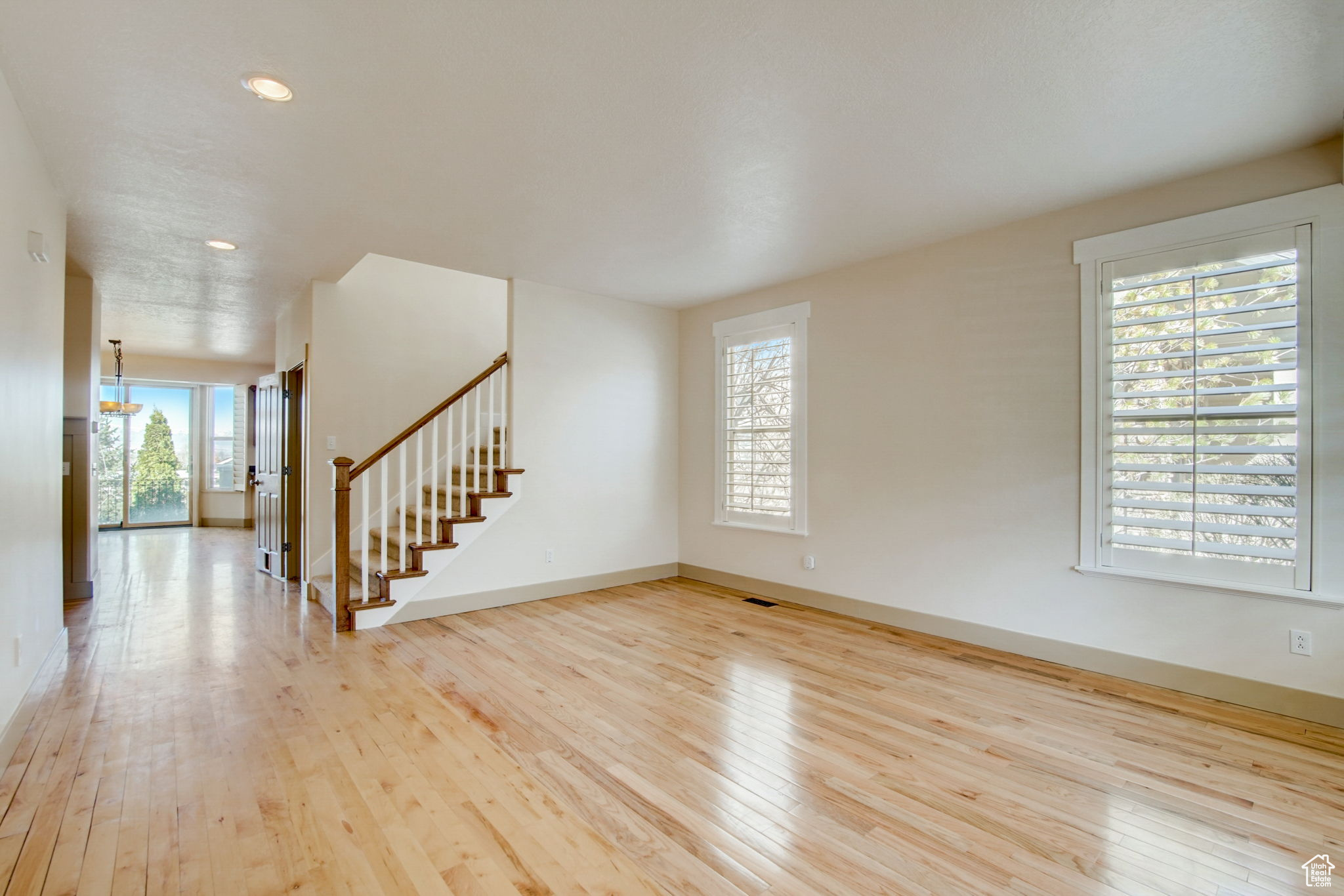 Spare room with light hardwood / wood-style flooring and plenty of natural light