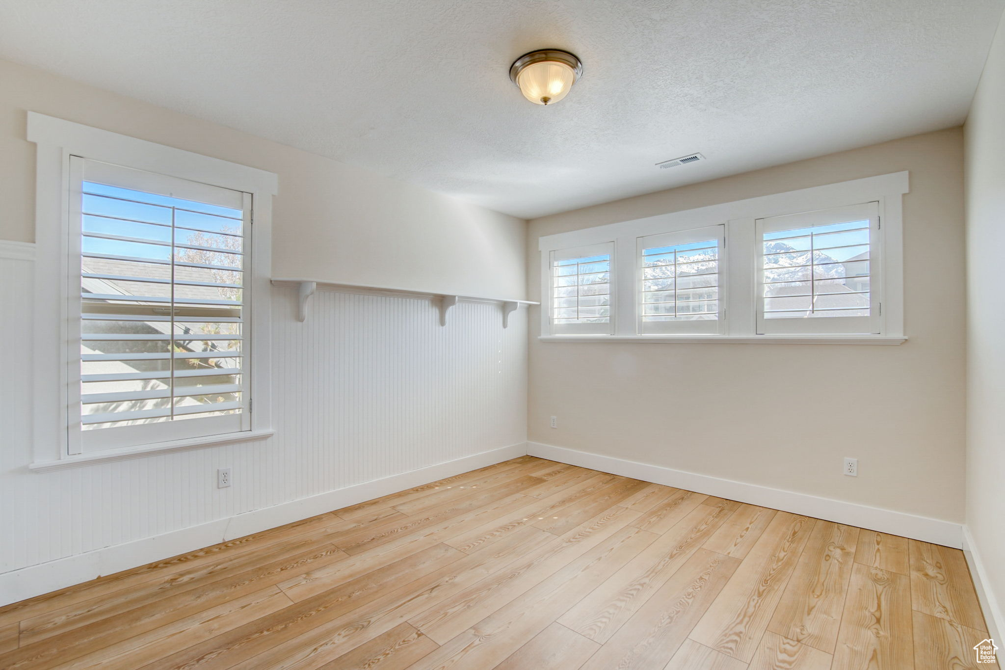 Empty room featuring light hardwood / wood-style flooring