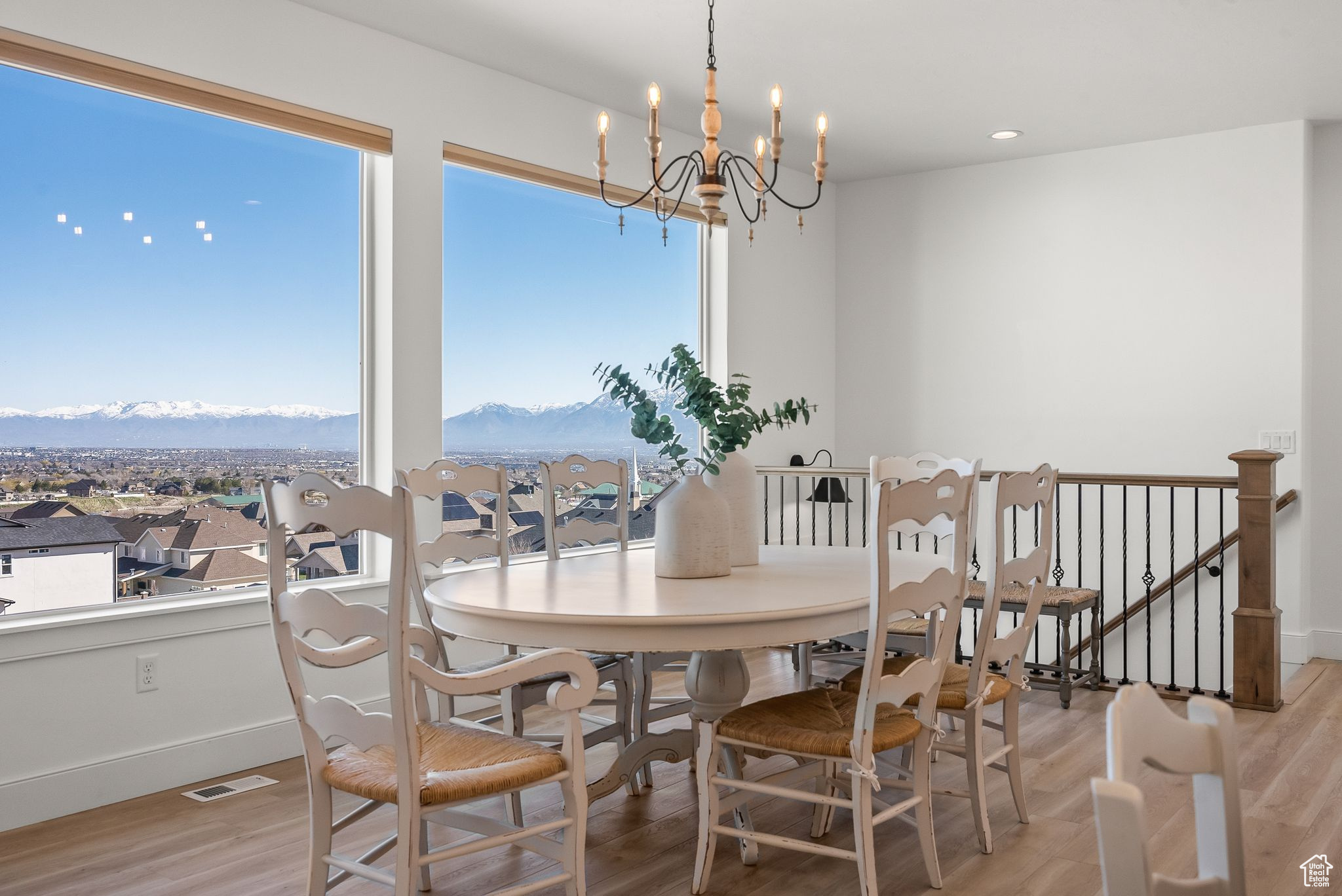 Dining area featuring a mountain view, light hardwood / wood-style floors, and a chandelier