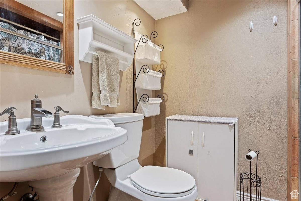 Bathroom featuring sink and toilet