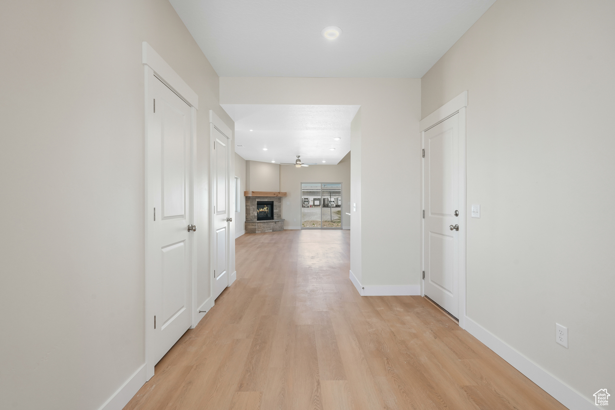 Hallway with light hardwood / wood-style flooring