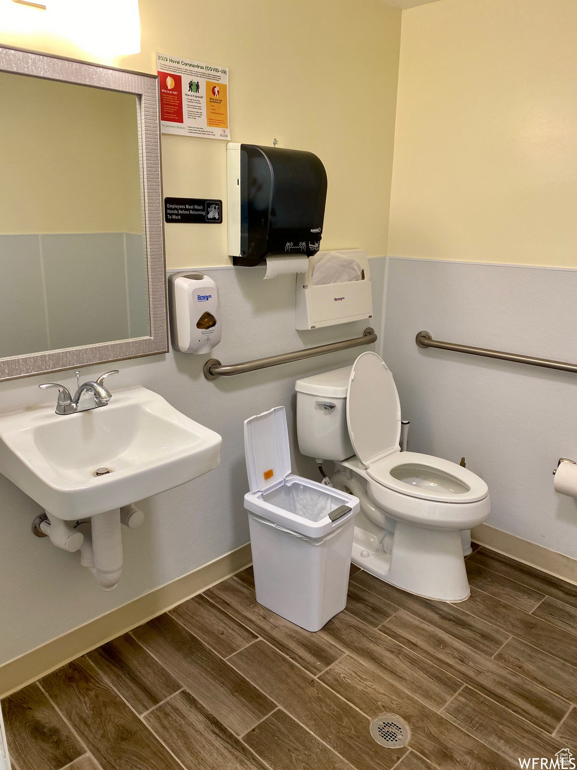 Bathroom featuring hardwood / wood-style flooring and toilet