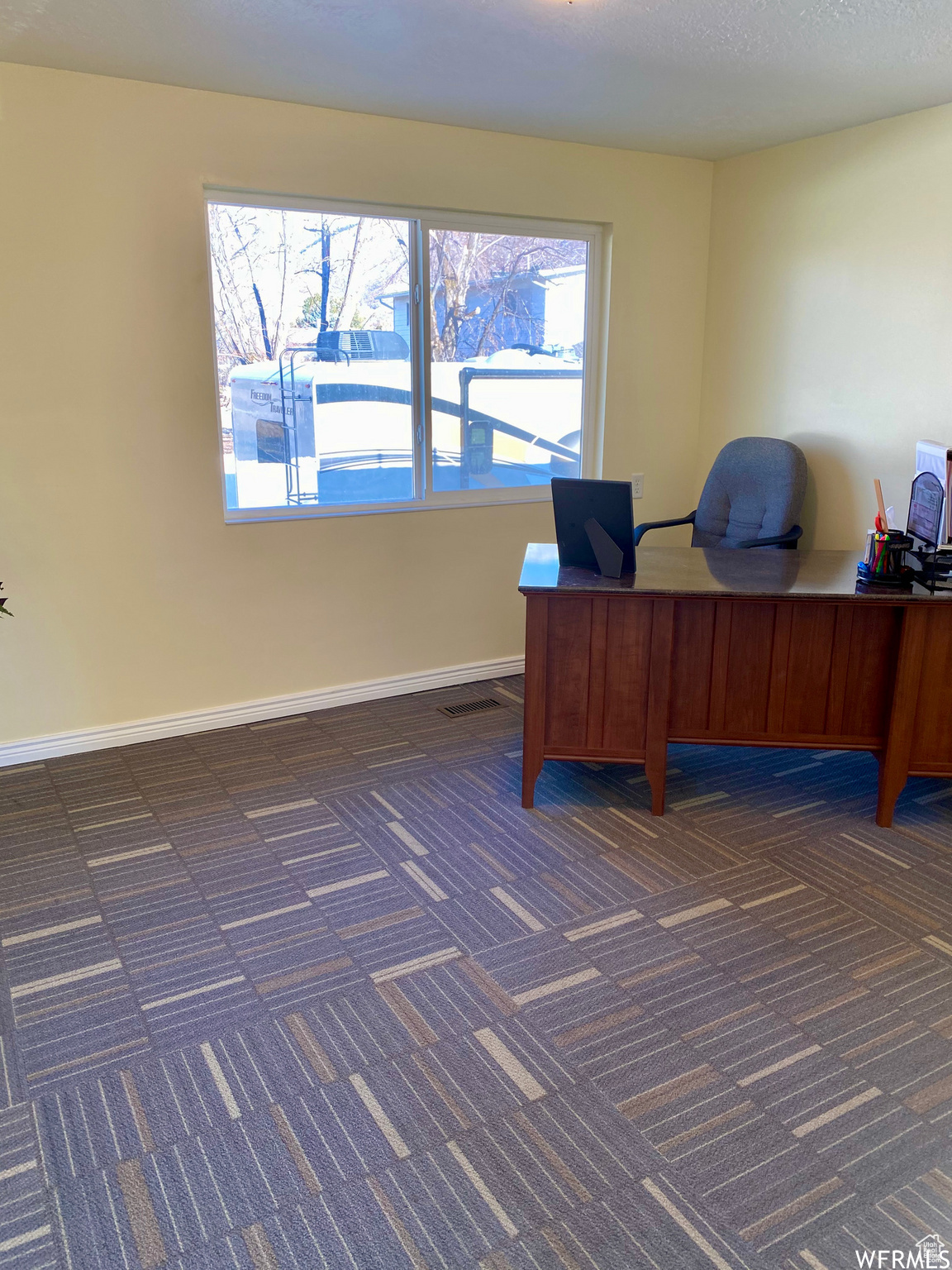 View of carpeted home office