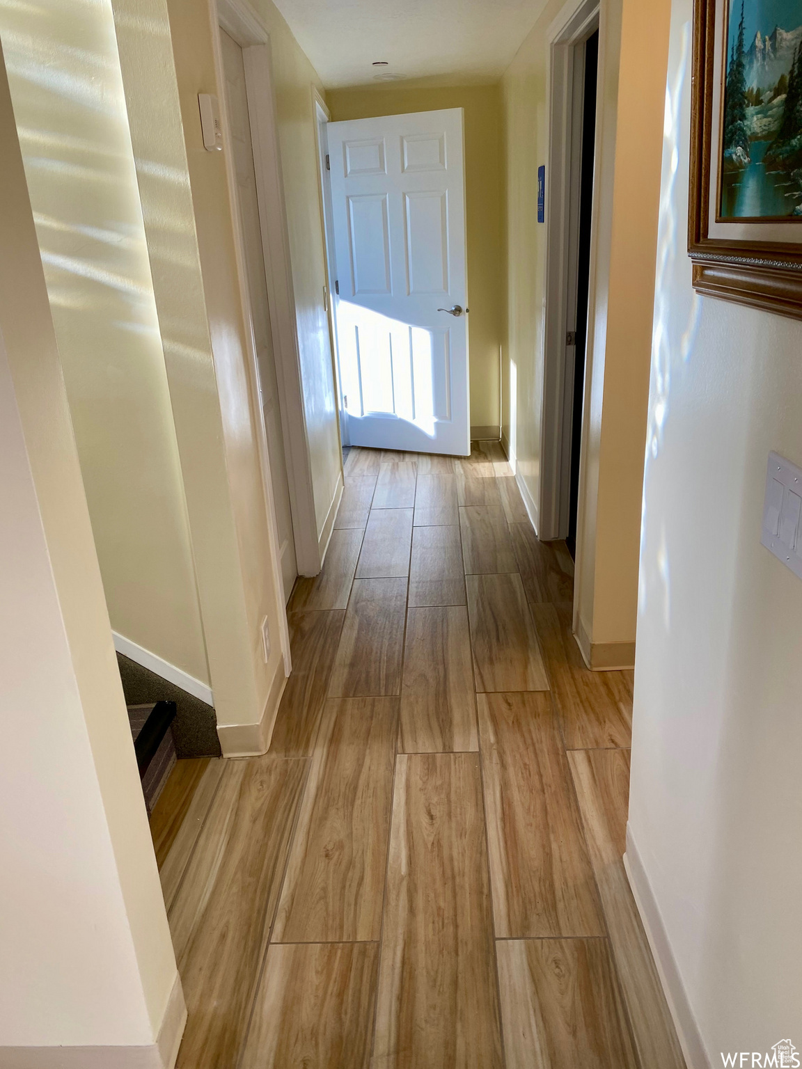 Corridor with light hardwood / wood-style floors