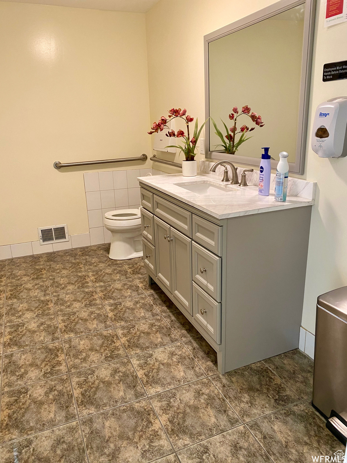 Bathroom with toilet, tile flooring, and vanity