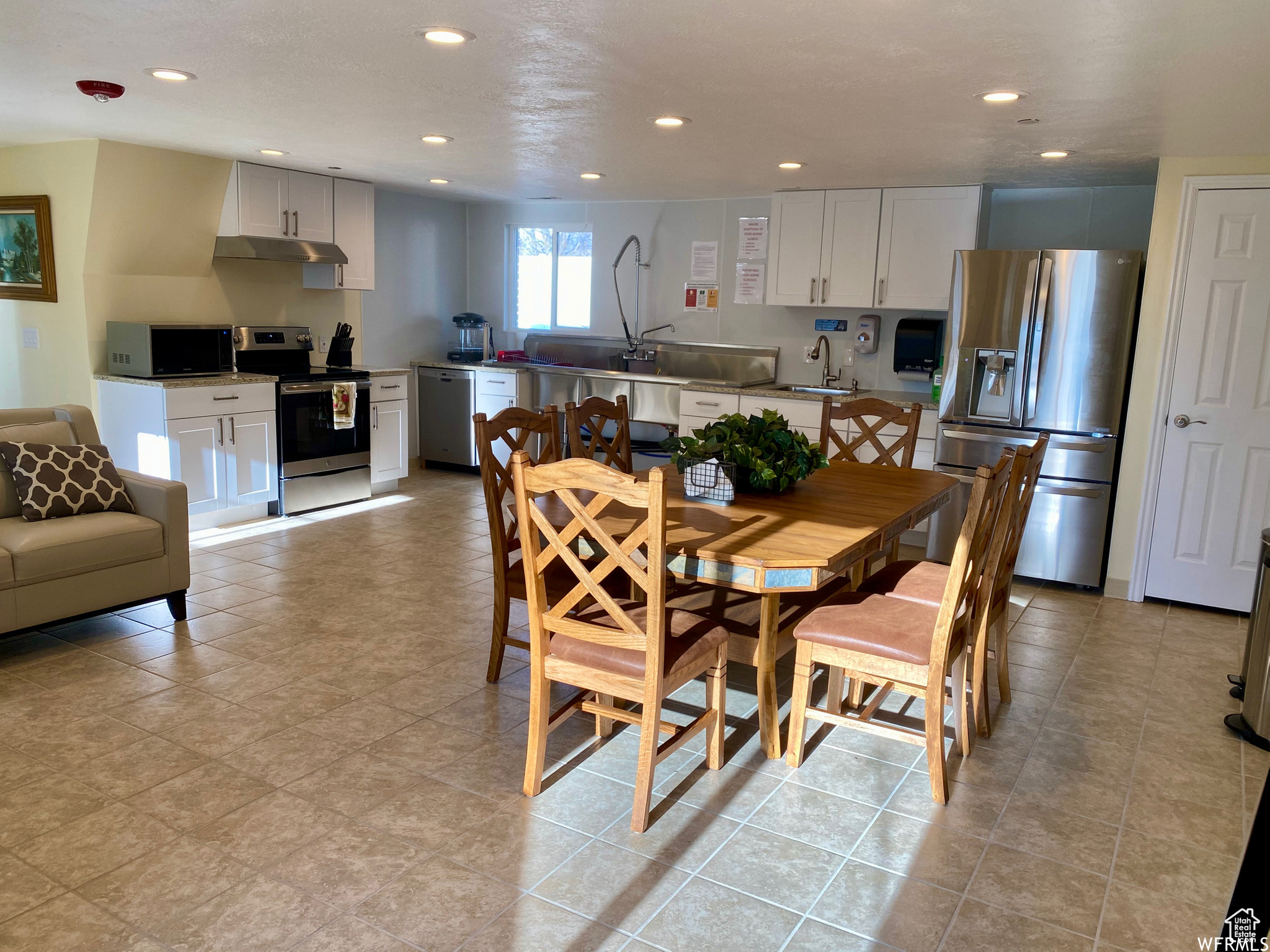 Dining room featuring sink and light tile floors