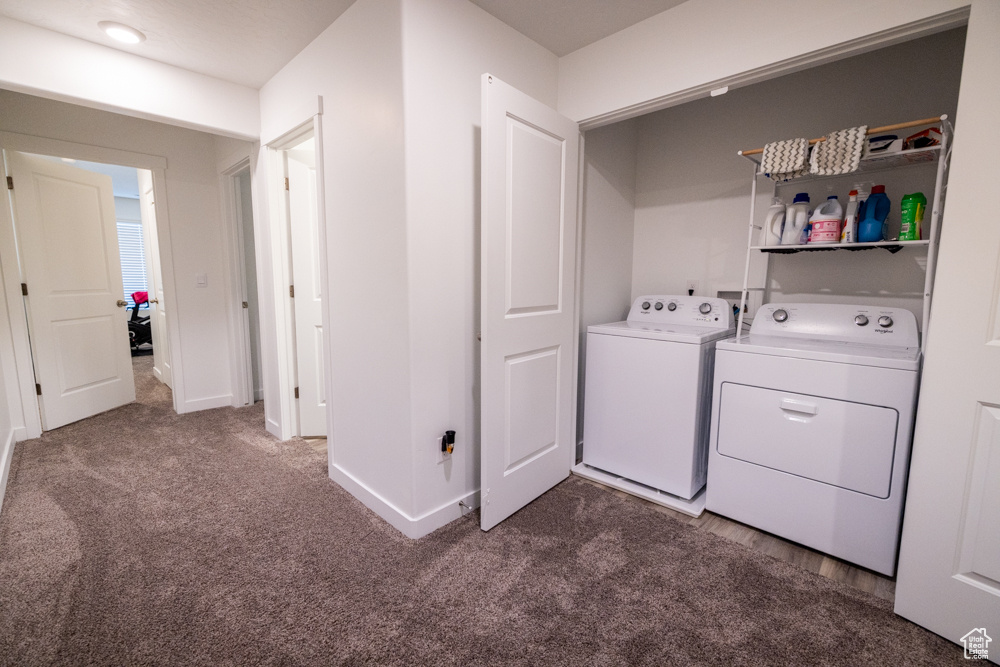 Clothes washing area featuring separate washer and dryer, washer hookup, and dark colored carpet