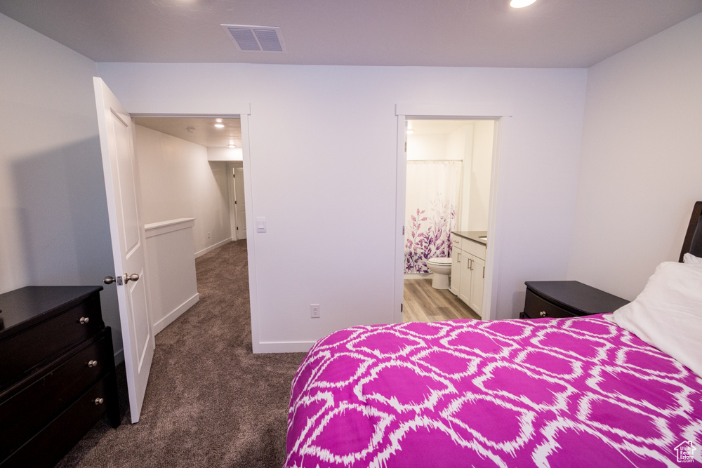 Carpeted bedroom with ensuite bathroom