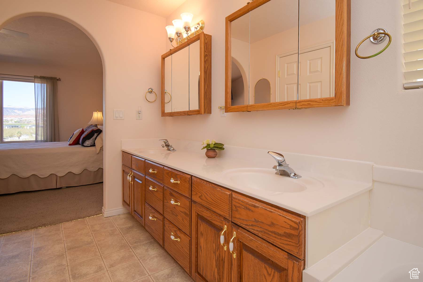 Primary bathroom featuring tile flooring and double sink vanity