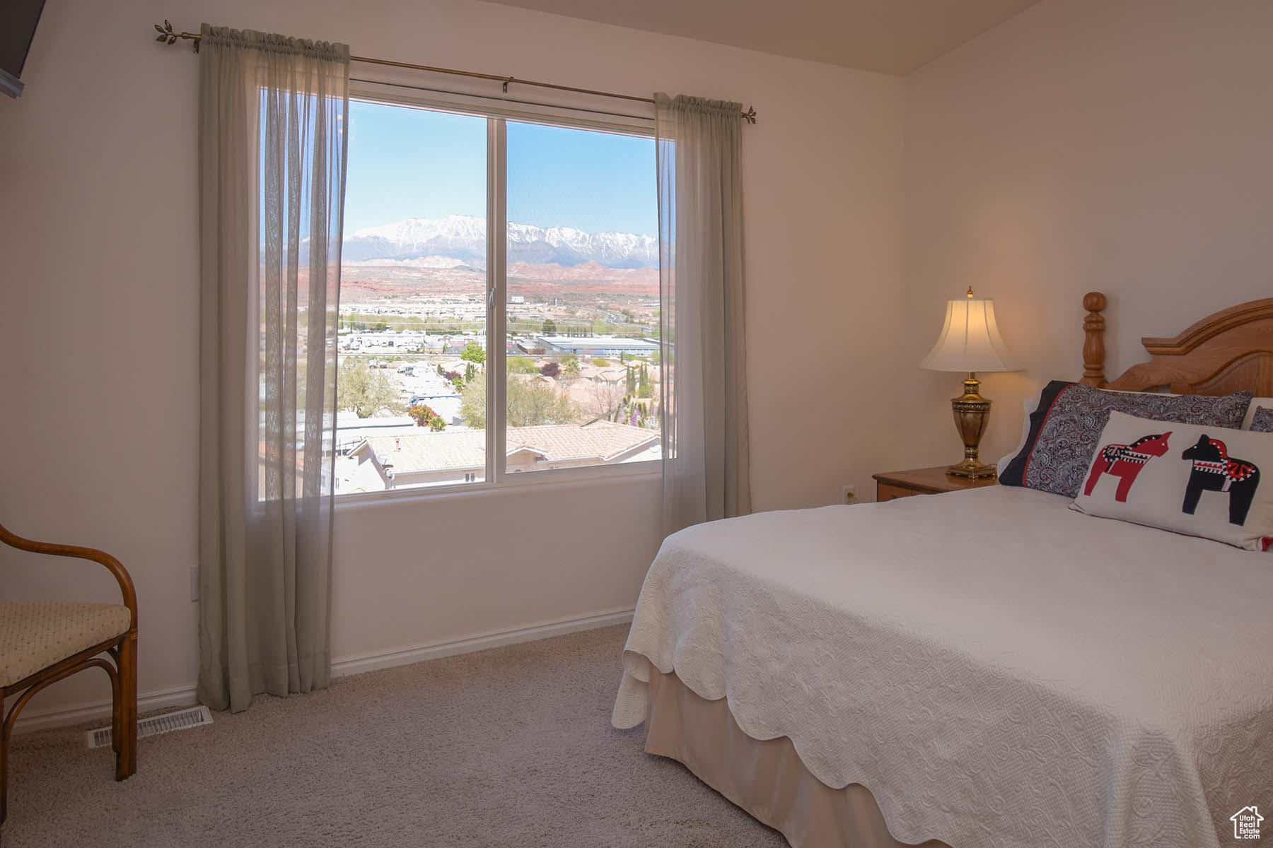 Primary bedroom featuring light colored carpet, views of Pine Valley Mountain