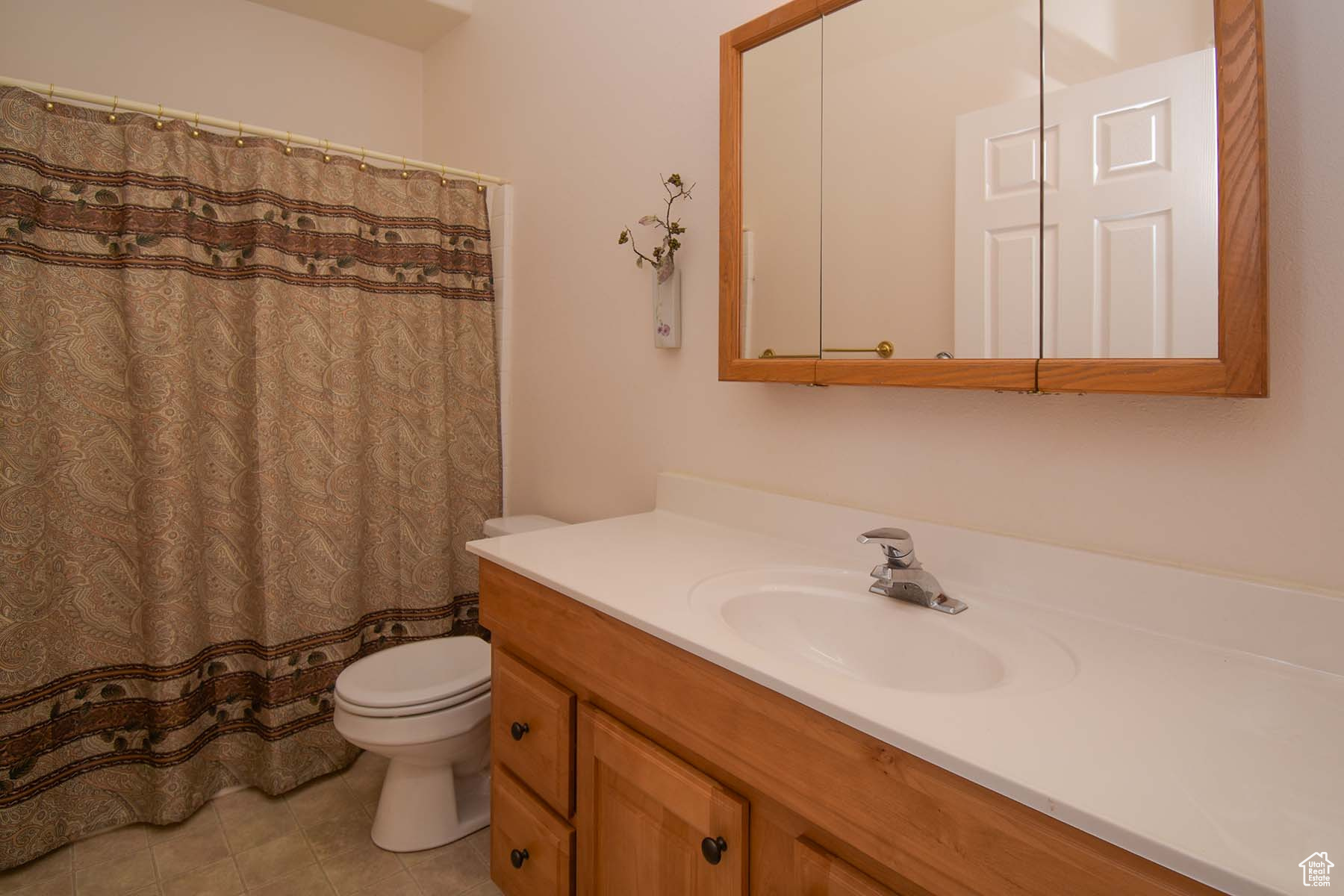 Guest bathroom with toilet, tile flooring, and oversized vanity