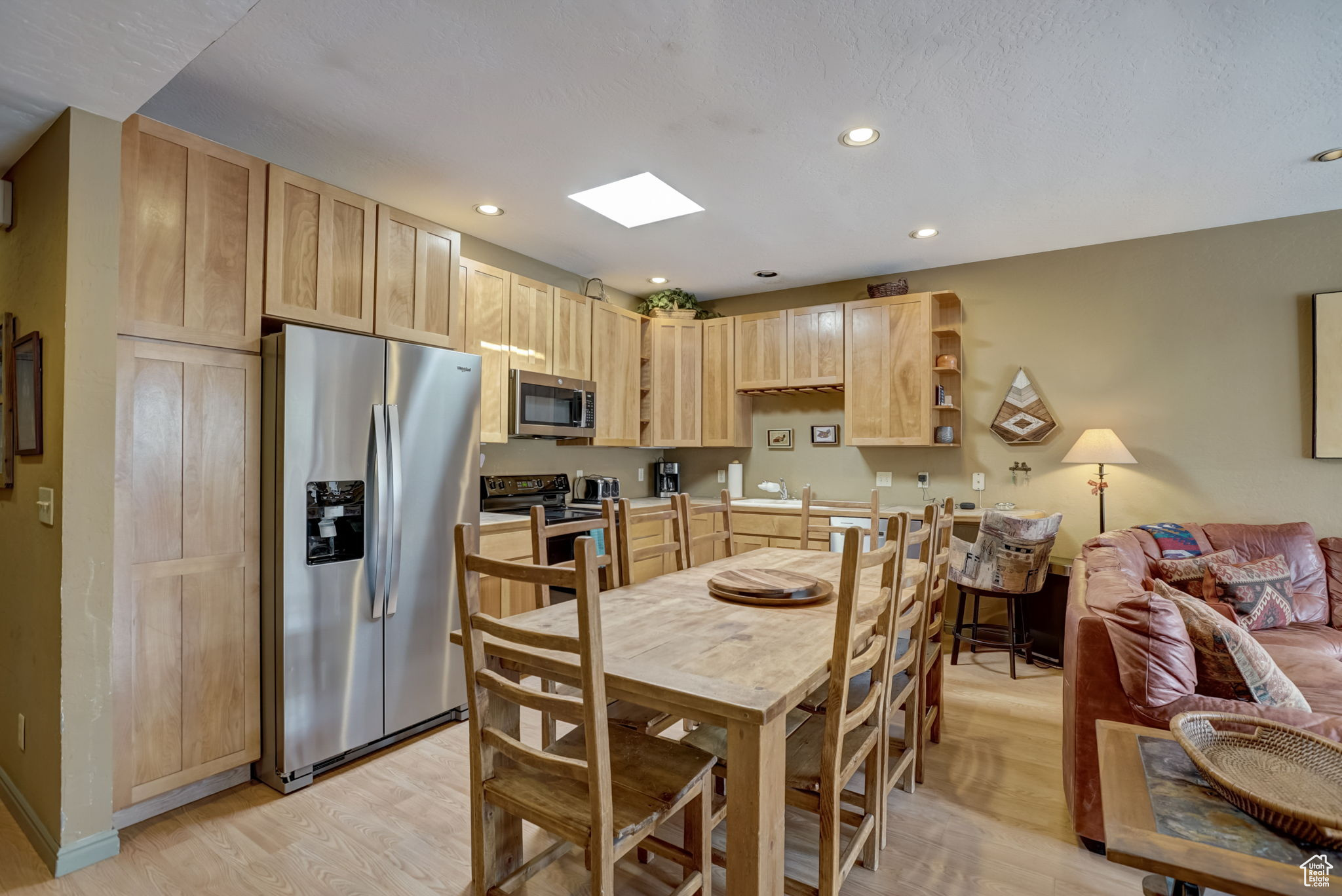 Kitchen featuring light brown cabinetry, light wood-type flooring, and stainless steel appliances
