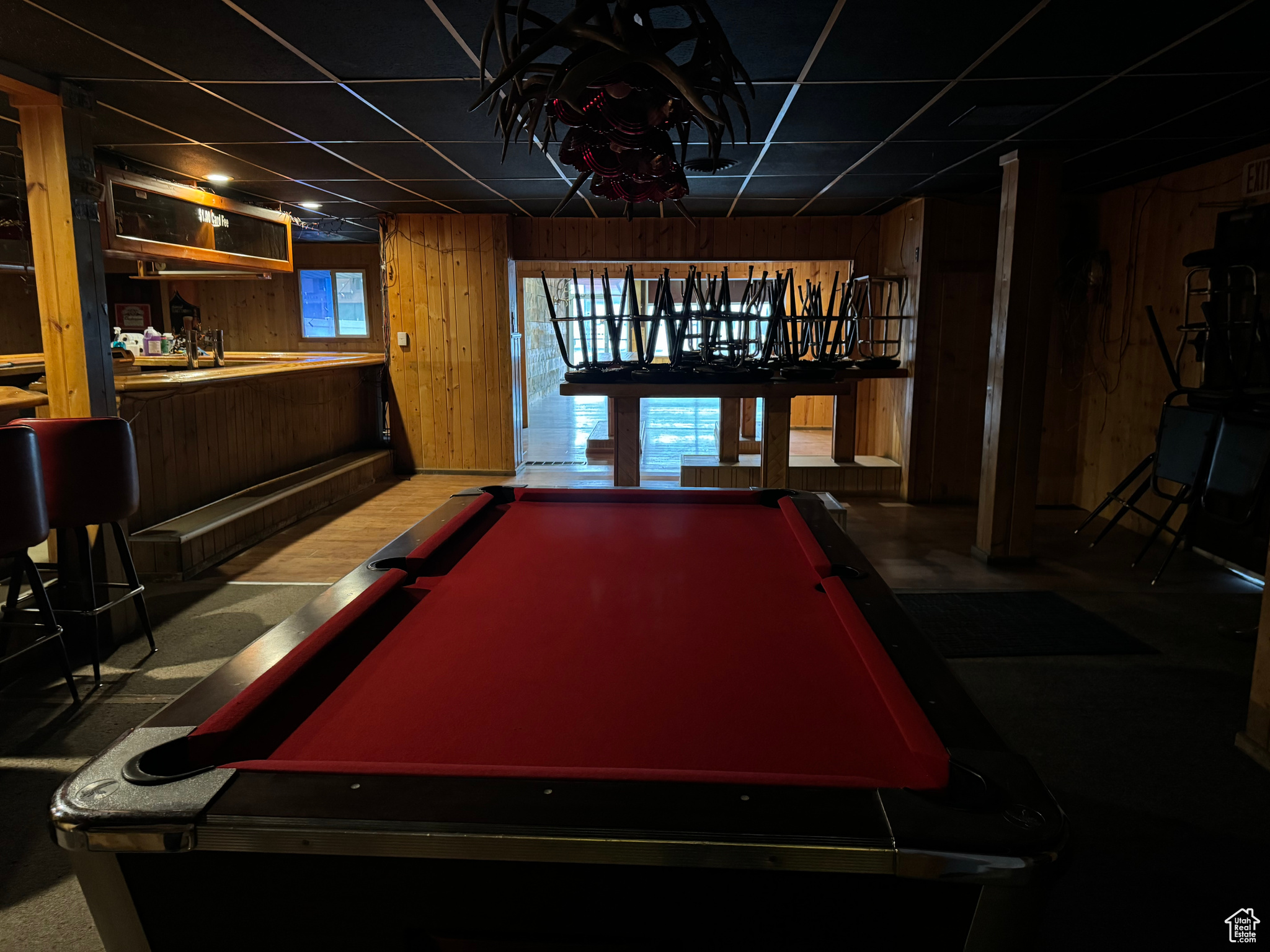 wealth of natural light, wooden walls, and pool table