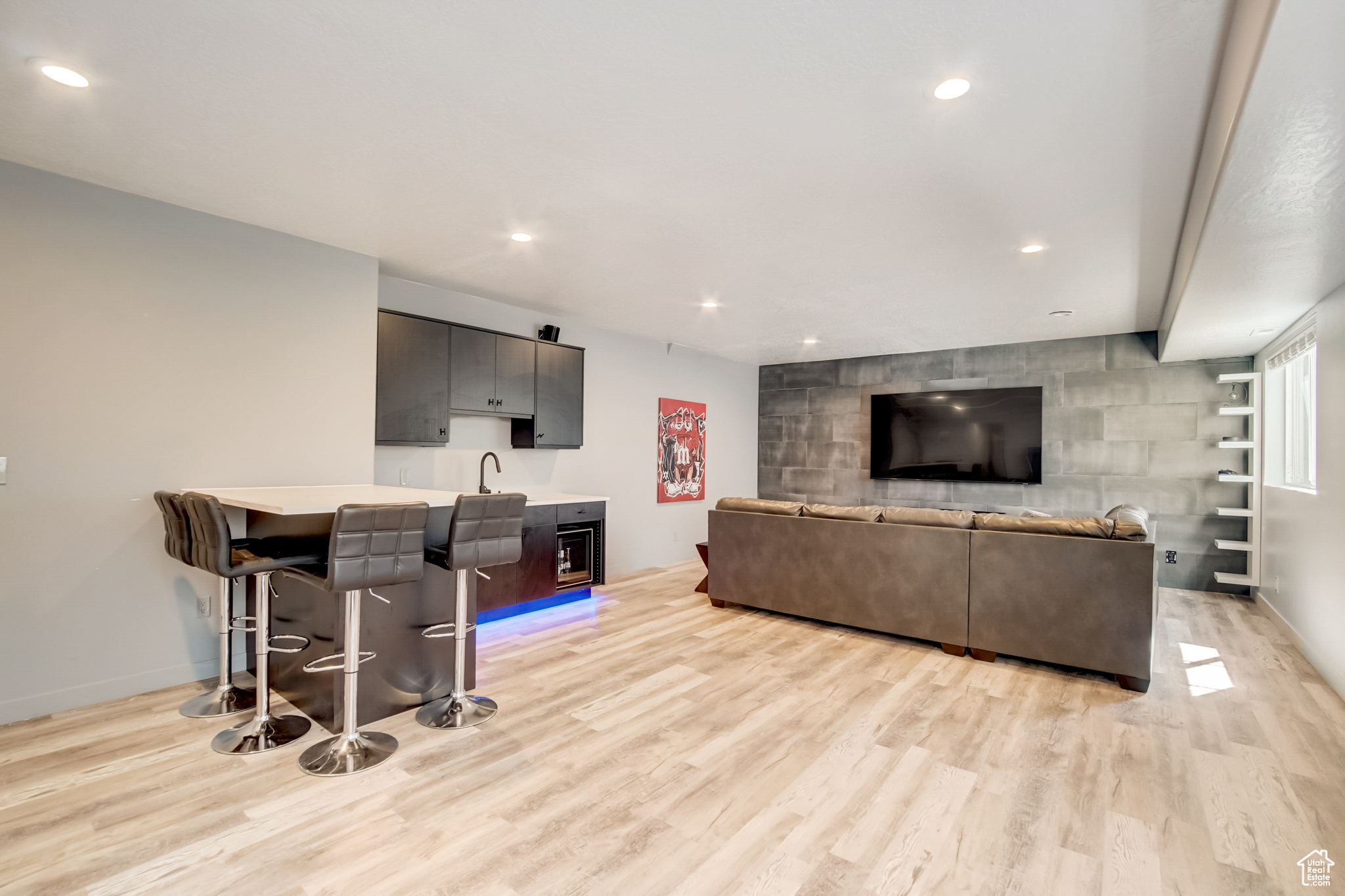 Living room featuring bar area and light hardwood / wood-style floors