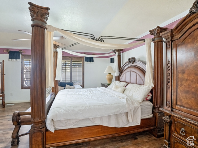 Bedroom featuring crown molding, ceiling fan, and dark wood-type flooring
