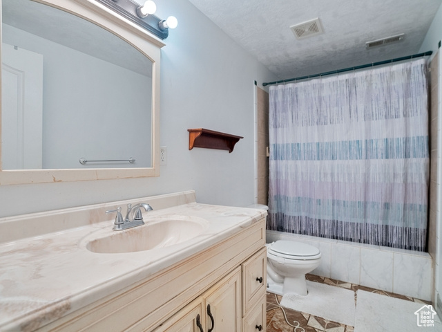 Bathroom with vanity, tile floors, and toilet